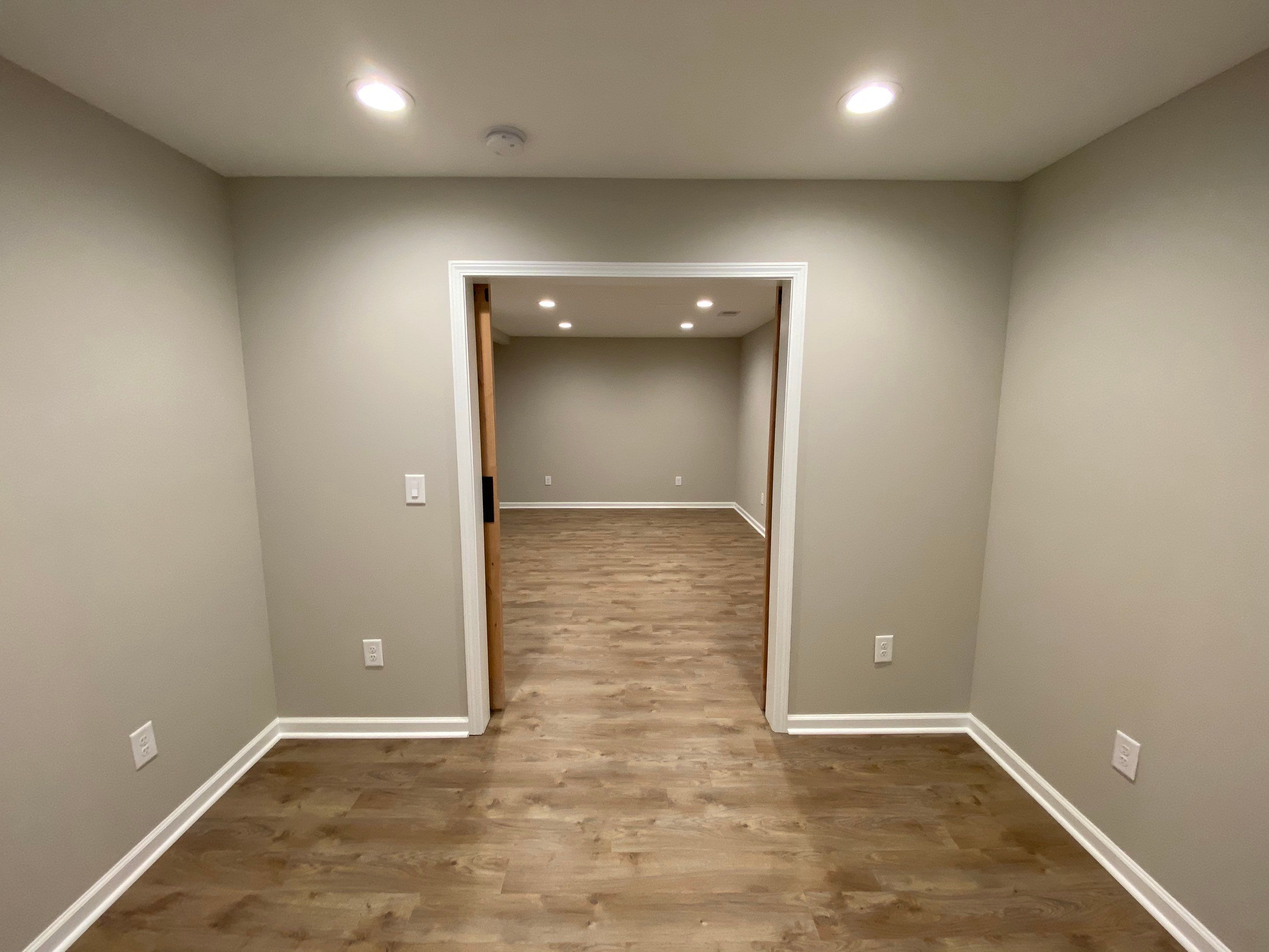 Acworth Basement Transformation With Wet Bar and Stone Fireplace by Swift Home Renovations