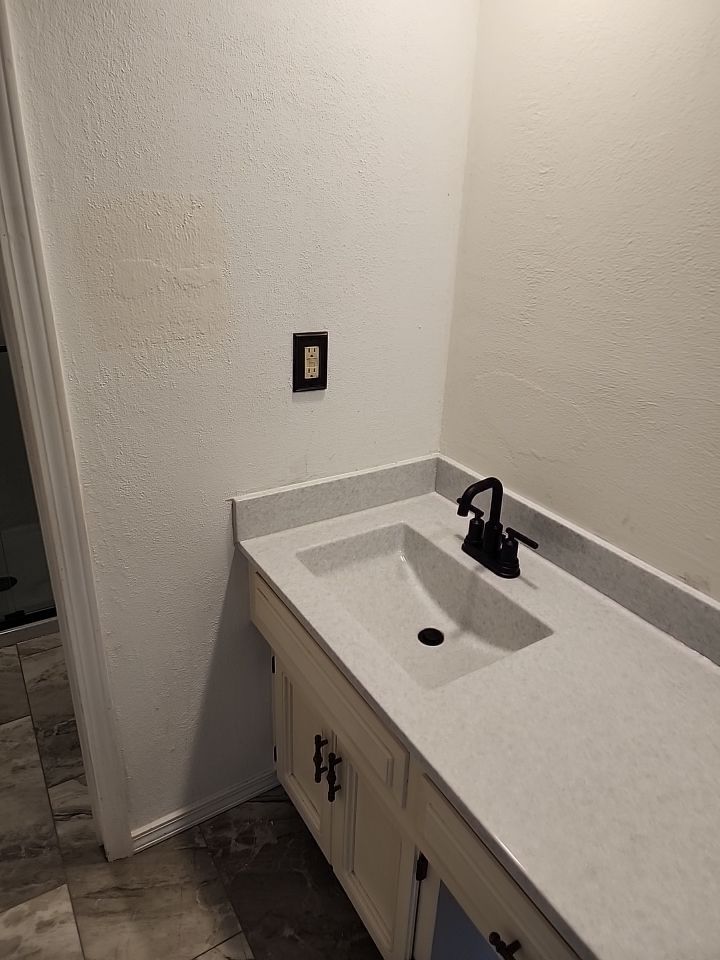 New shower, flooring, and countertop by The Shower Company