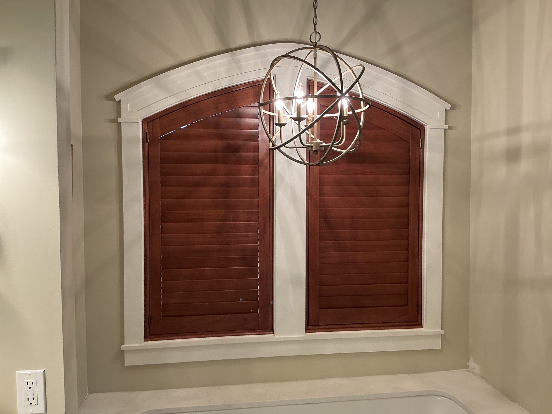 Stained Wood Plantation Shutter Upgrade for Arched Windows in St Joseph by tracy.hickman@budgetblinds.com