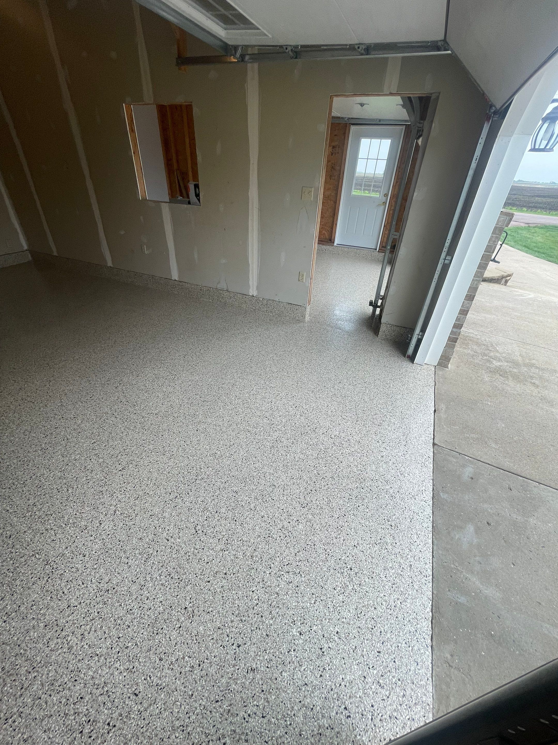 Speckled Epoxy Floor Coating Installation for Centerville Residential Garage by Select Painting, Coatings & Garage Cabinets