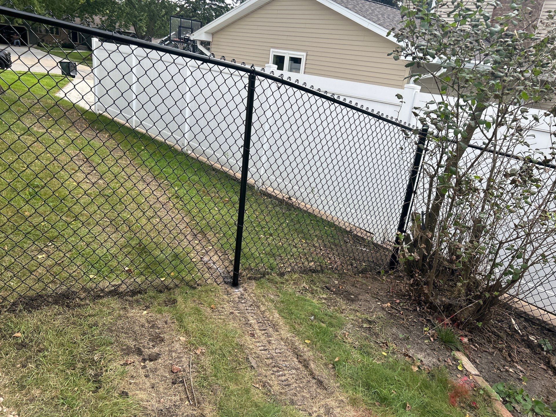Black Vinyl Coated Chain Link Fence Installation in Waterloo by Perfect Picket Fence and Stain