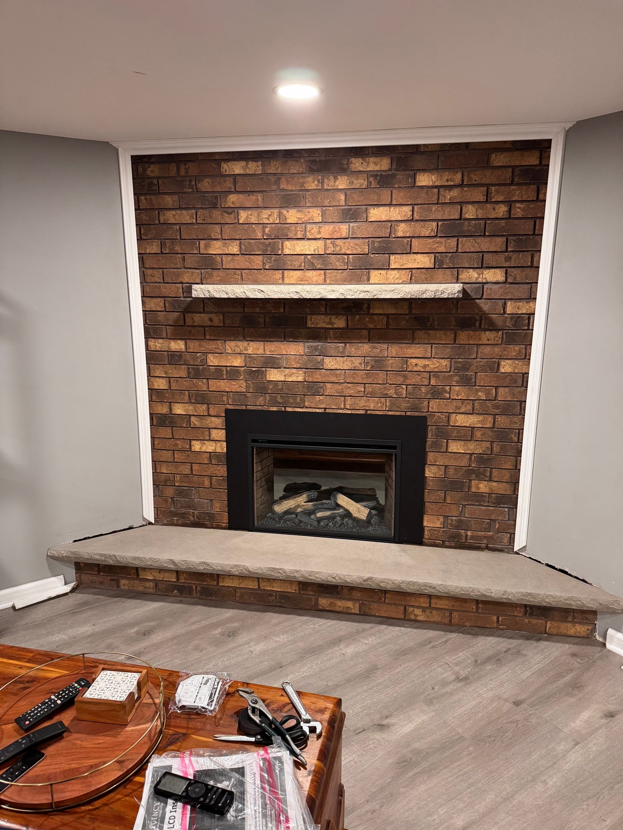 Electric Fireplace and Limestone Hearth & Mantel Installation by Leonard and Sons Building Services, Inc.