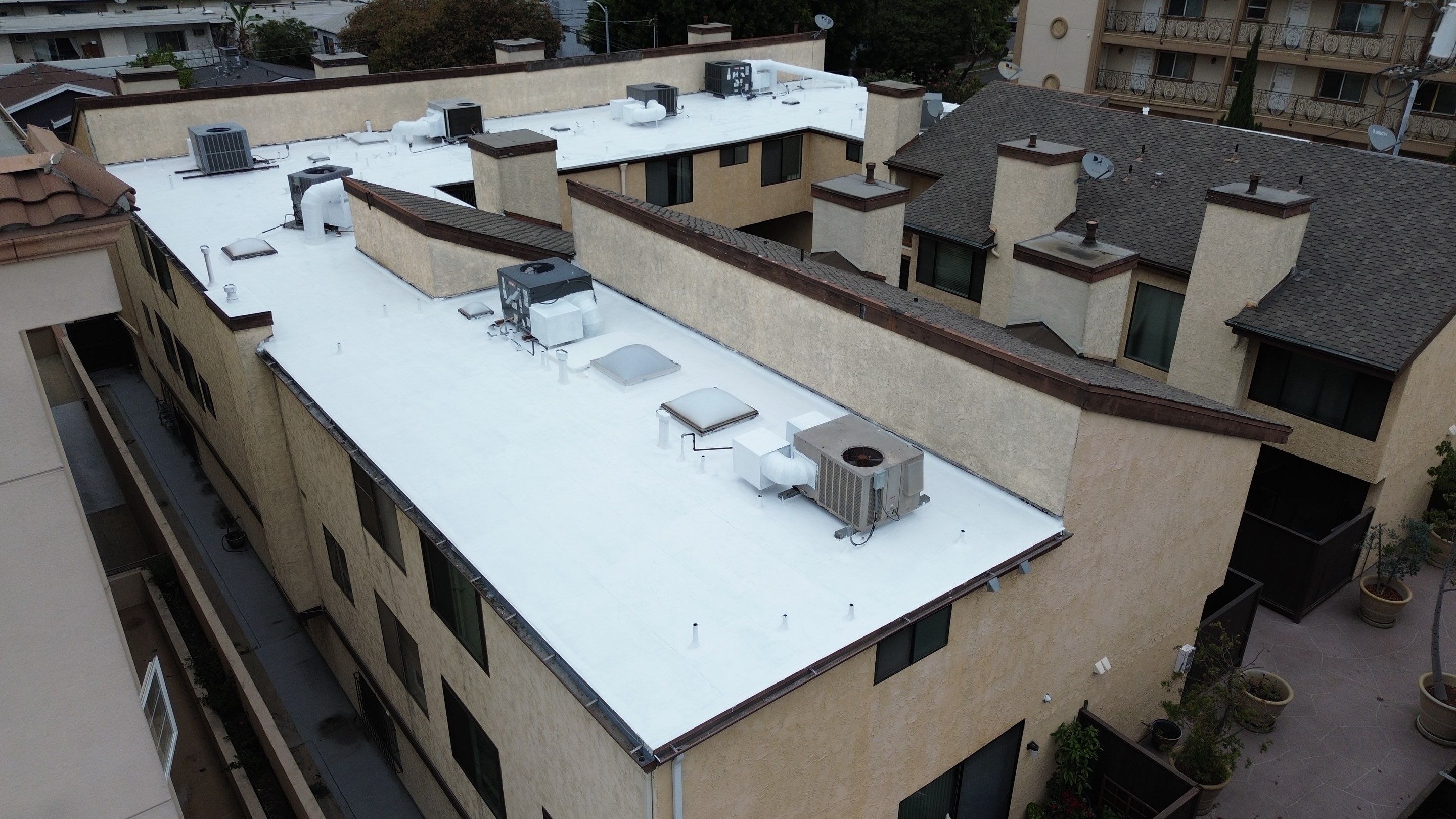 Apartment Building Silicone Coating by Hull Brothers Roofing