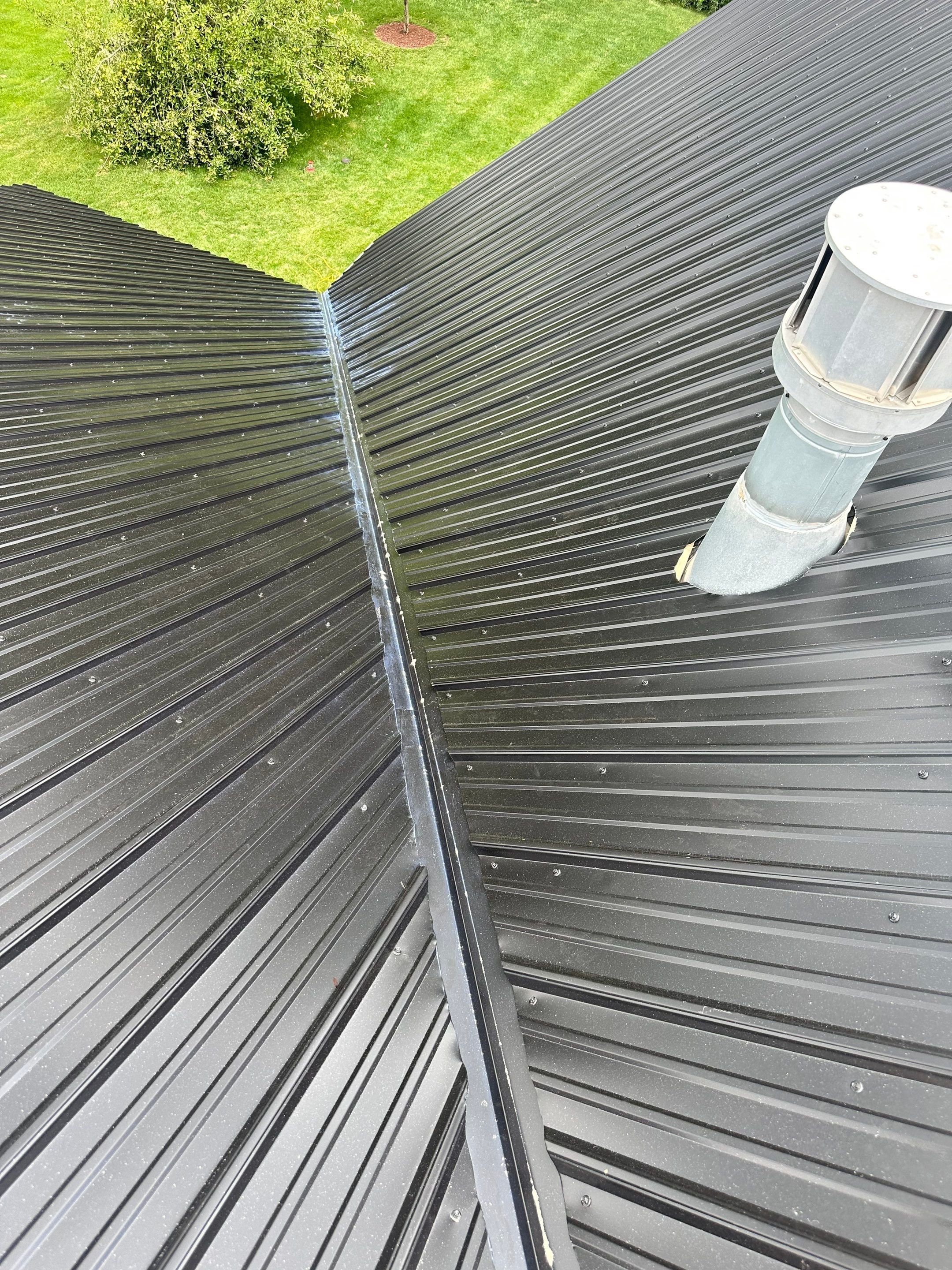 Standing seam / Azm panel in black  by Teflon Roofing