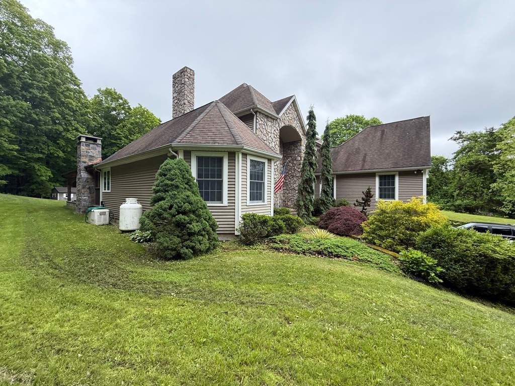 Bold Siding transformation with Cert Cedar Board & Batten S12, White, and Cert Monogram D/4 x 12'6" clapboard, Tuxedo by DiGiorgi Roofing and Siding Inc