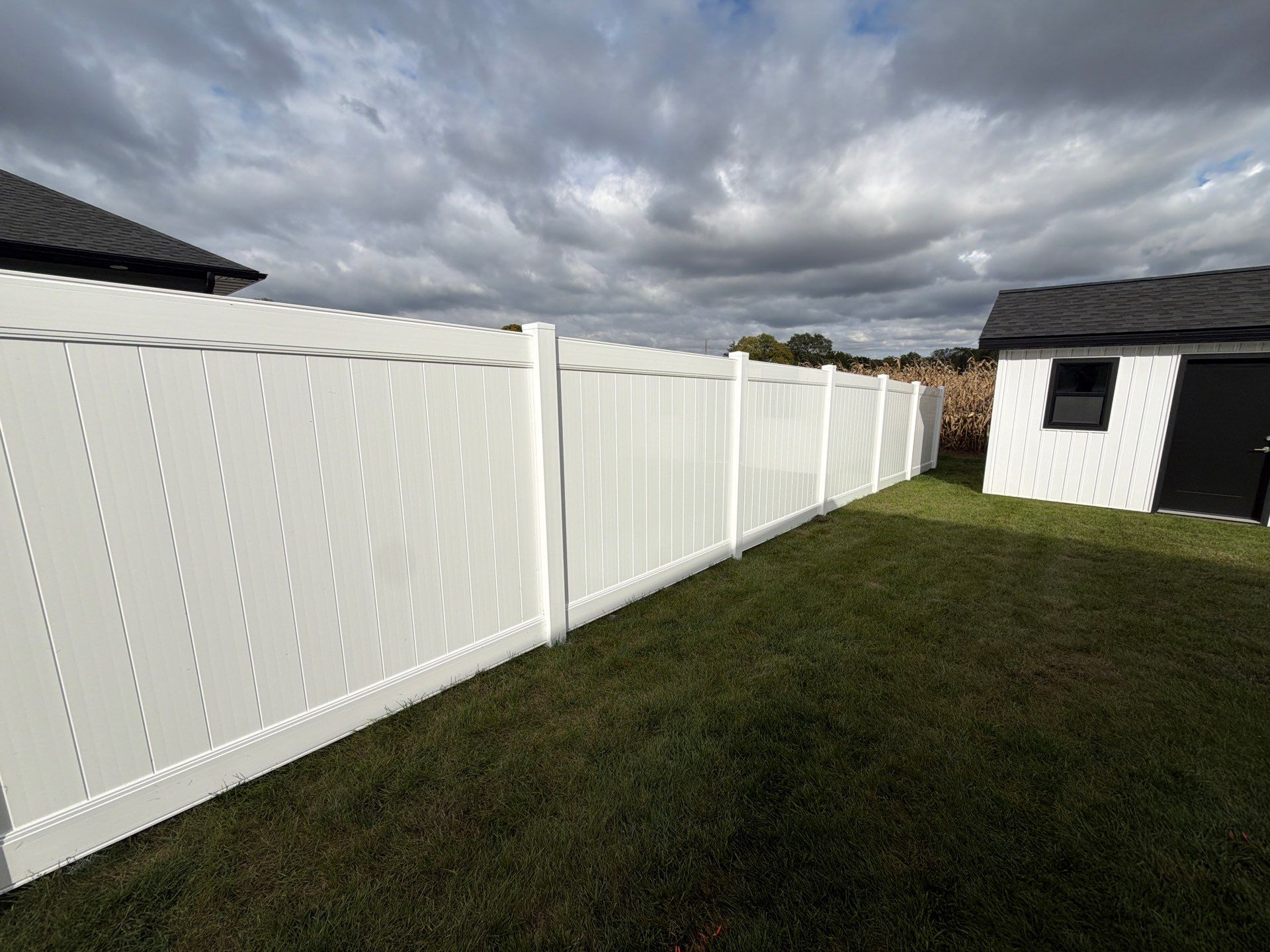 Residential White Vinyl Privacy Fence Installation in Janesville by Perfect Picket Fence and Stain