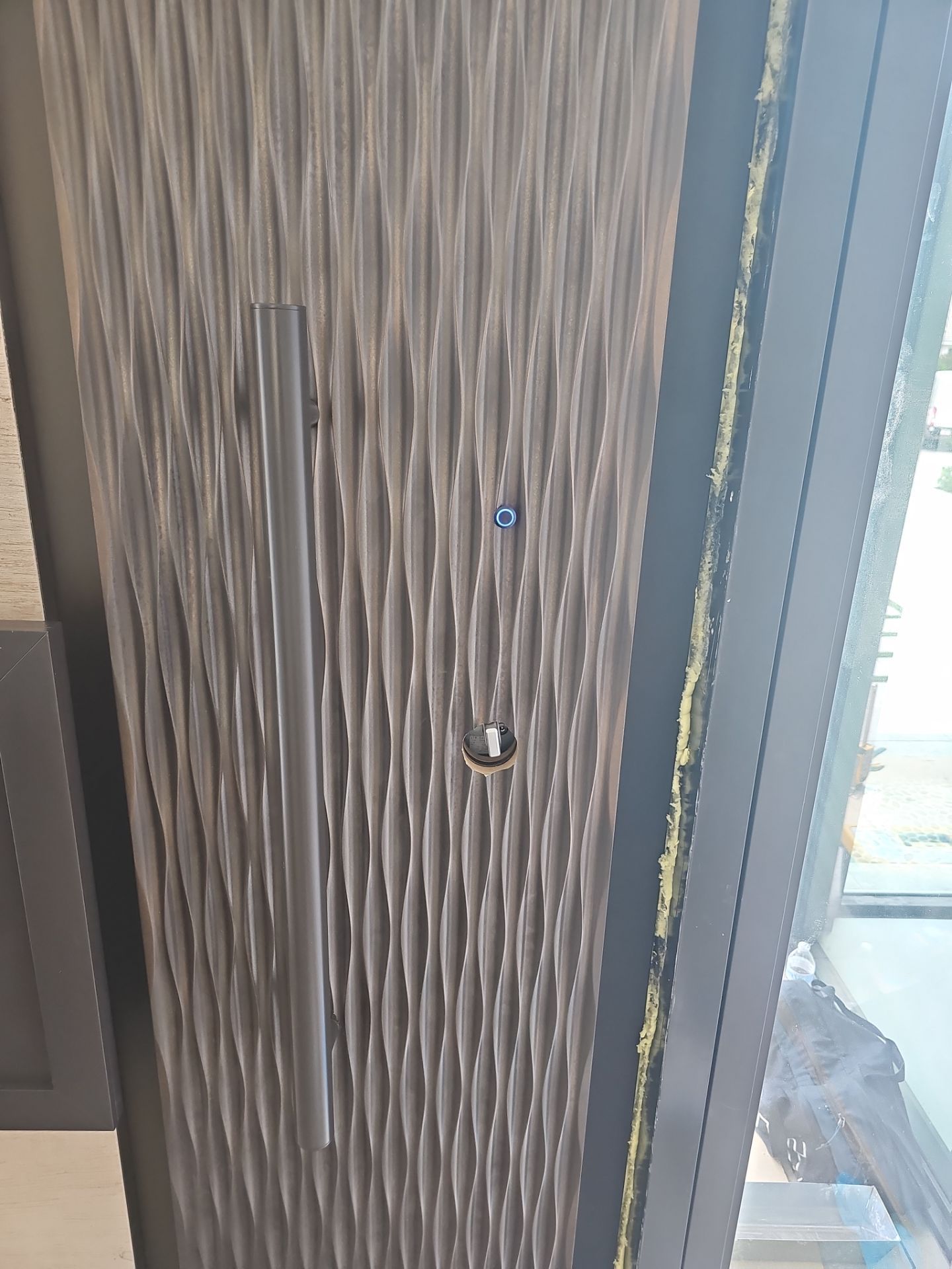 This stunning custom pivot door is a true statement of security and luxury, installed in the heart of Boca Raton. Designed to withstand the harshest conditions, it is hurricane-certified, ensuring unparalleled strength and protection. The door features a bespoke metal finish, exuding modern elegance while complementing the surrounding architecture. A custom metal door handle enhances its unique aesthetic, blending seamlessly with the door’s bold presence. Beyond its striking appearance, this door is equipped with advanced security technology, including a motorized lock for effortless access control and a self-closing feature for seamless functionality. A masterpiece of craftsmanship and innovation, this installation embodies the perfect fusion of security, design, and cutting-edge automation—a true reflection of FBS’s commitment to excellence. by FBS Systems Inc
