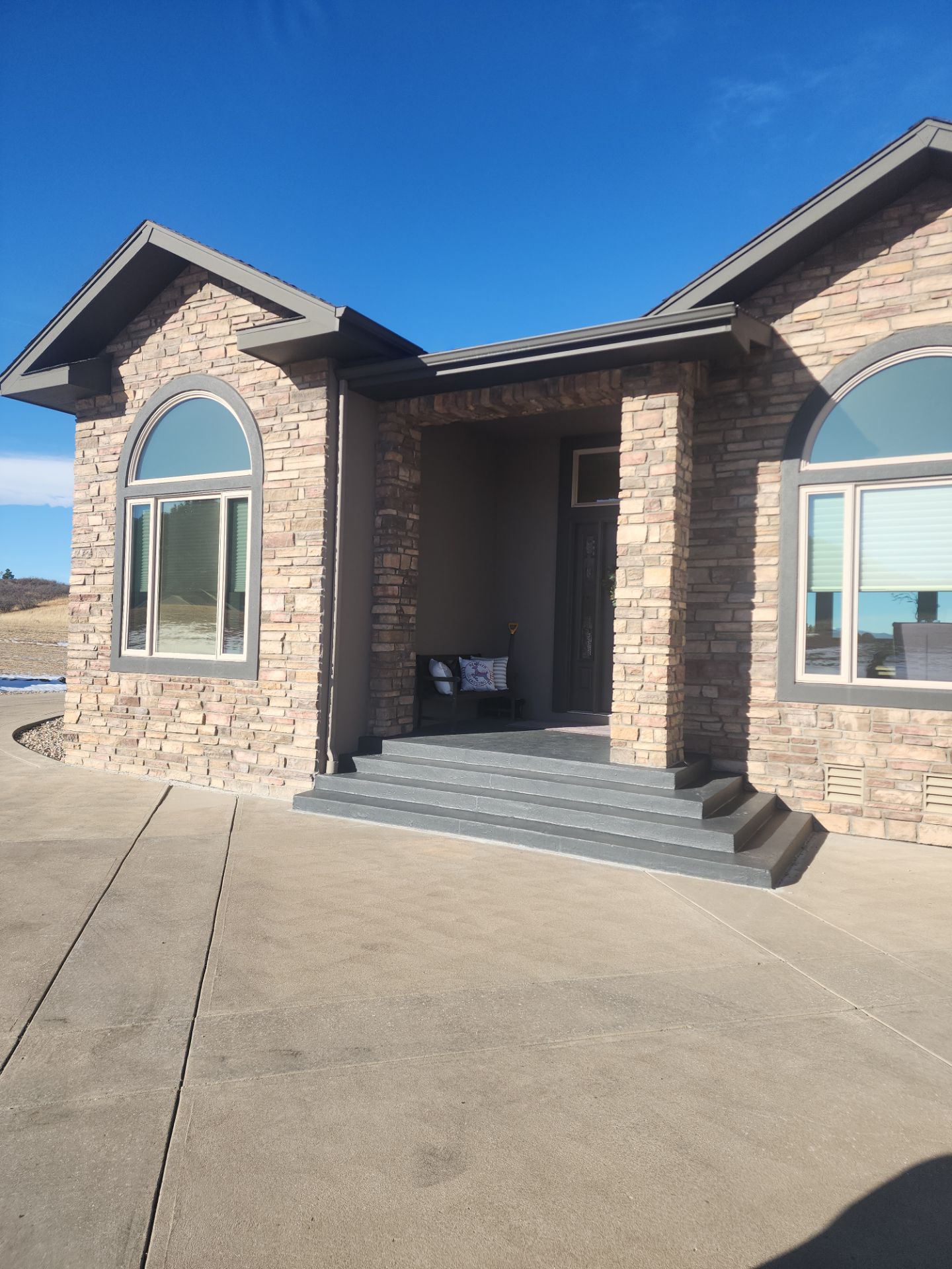 Castle Rock Elegance: White Stucco Exterior with Bold Tricorn Black by J&M Painting LLC