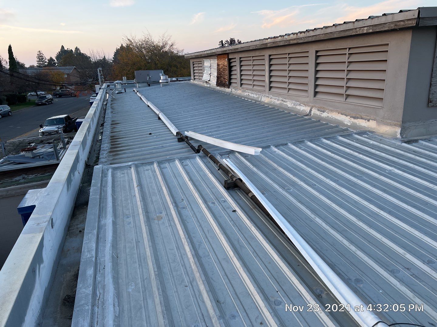 Metal roof restoration on commercial roof using Conklin Benchmark/ PUMA XL acrylic coatings over metal and foam by Straight Edge Roofing Inc