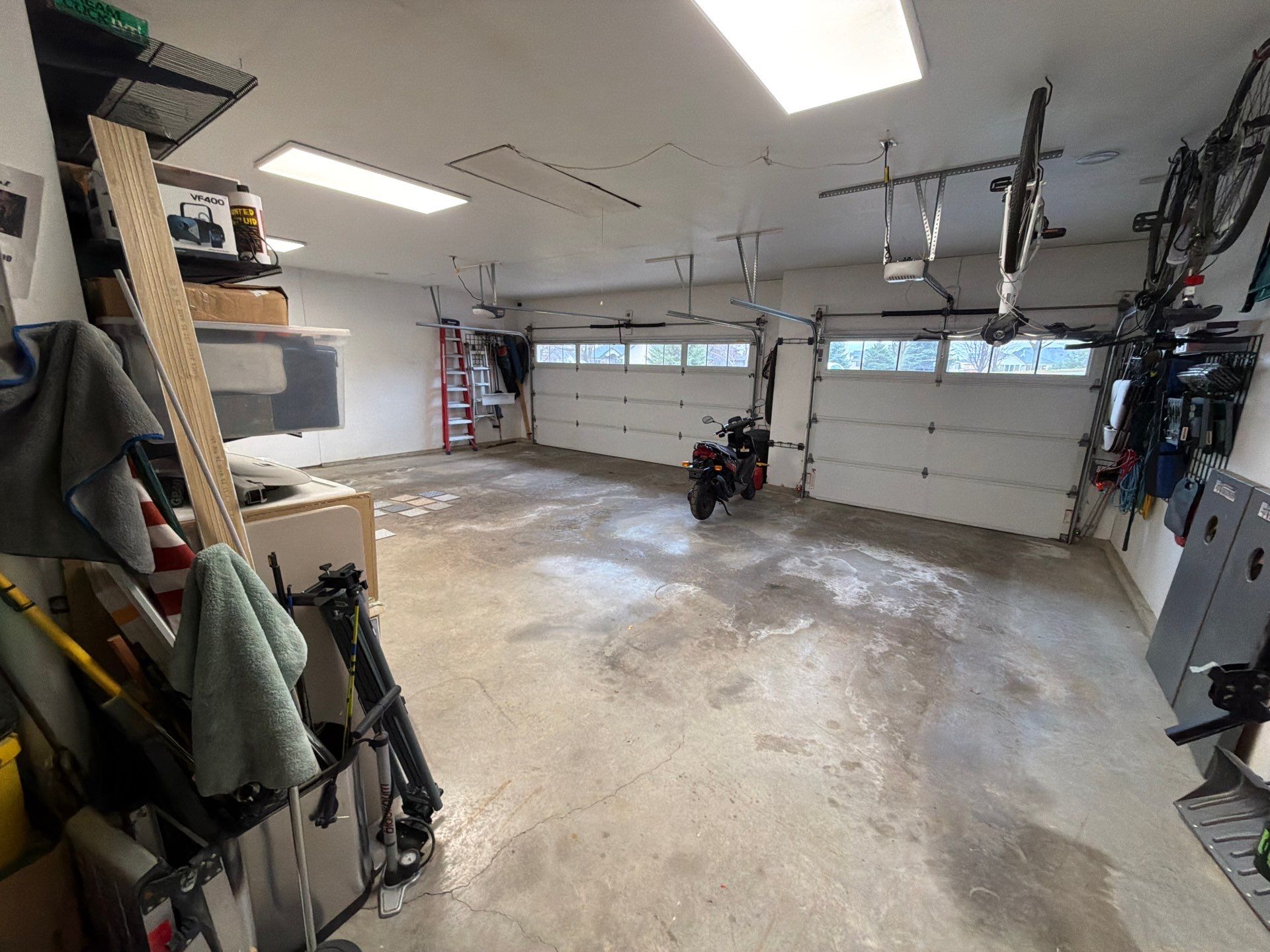 Feather Grey Garage Floor Coating Installation in Sioux Falls by Select Painting, Coatings & Garage Cabinets