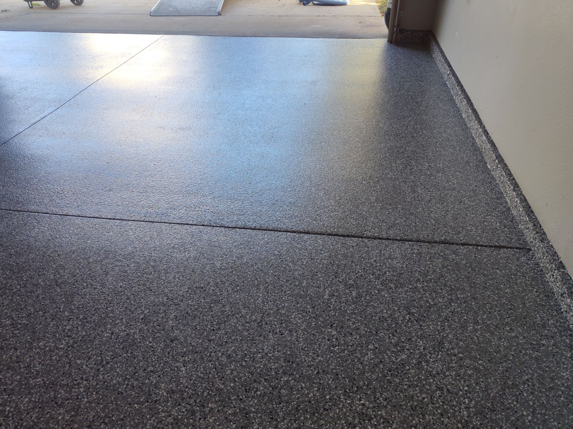 Close Up View of This Customer's New Flake Coating by Revival Concrete Coatings