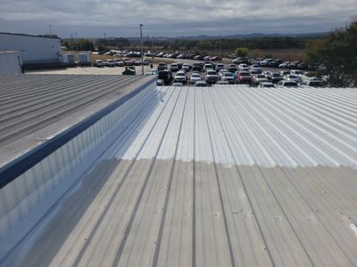 Finished white metal roof with clear sky background