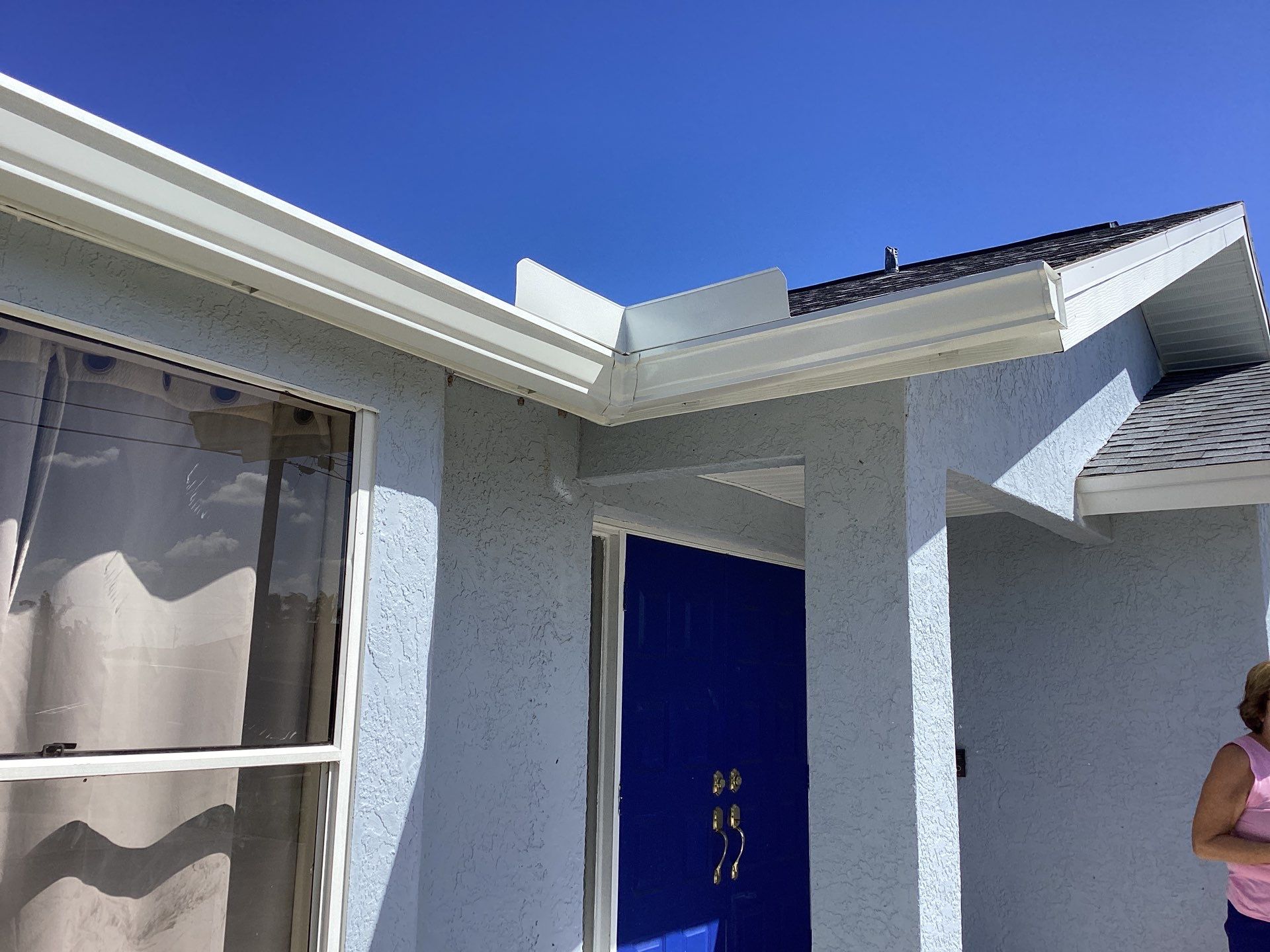 New White Seamless Gutters with Downspouts and Splash Guards in Cape Coral FL by Gutter Professors