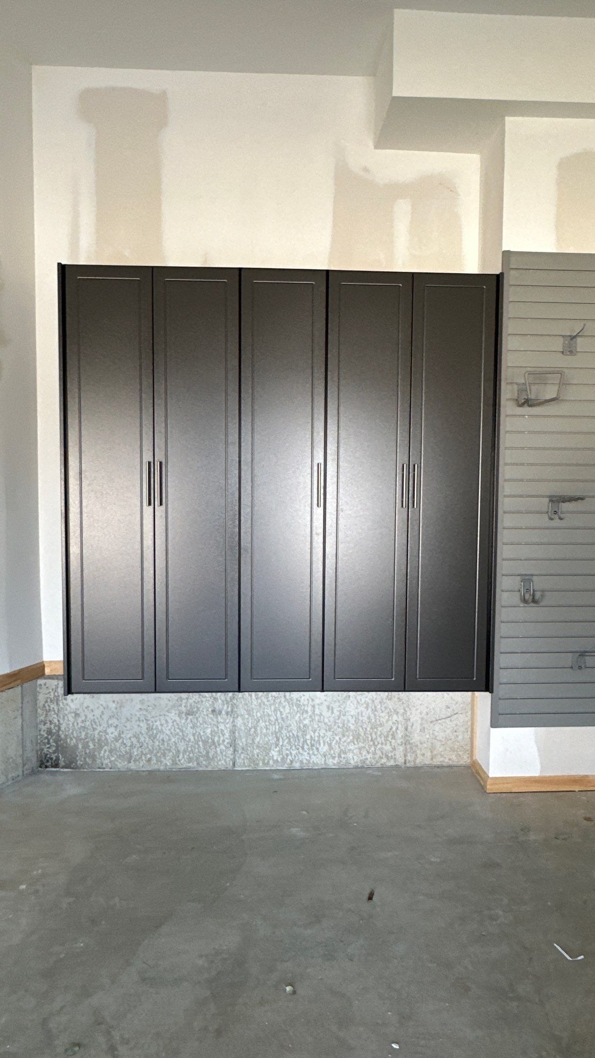 Megan J. added cabinets and slotwall to her garage. Plus a New Floor by Banner Garage