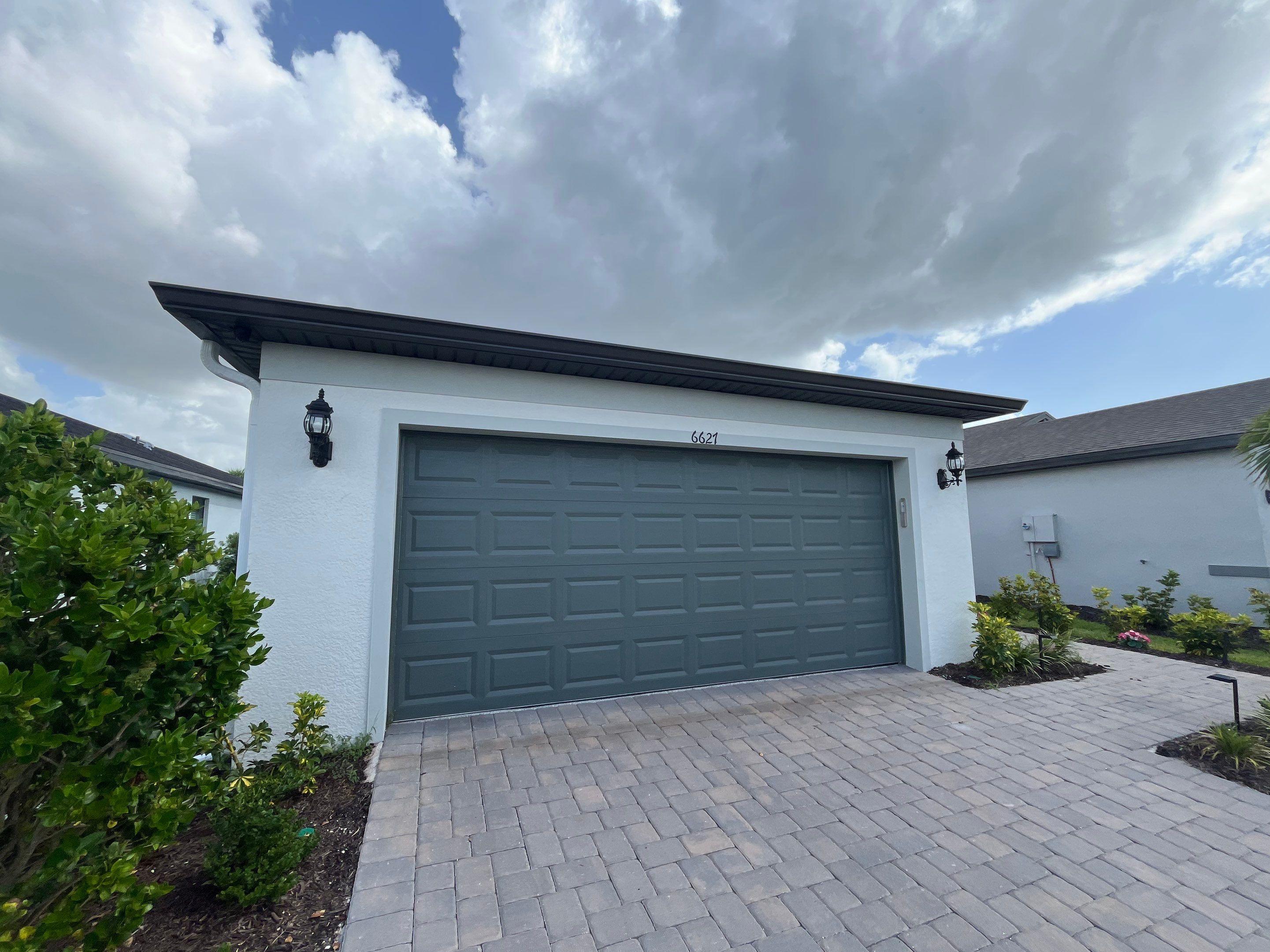 Dark Bronze Gutters and White Downspouts in Sarasota FL by Gutter Professors