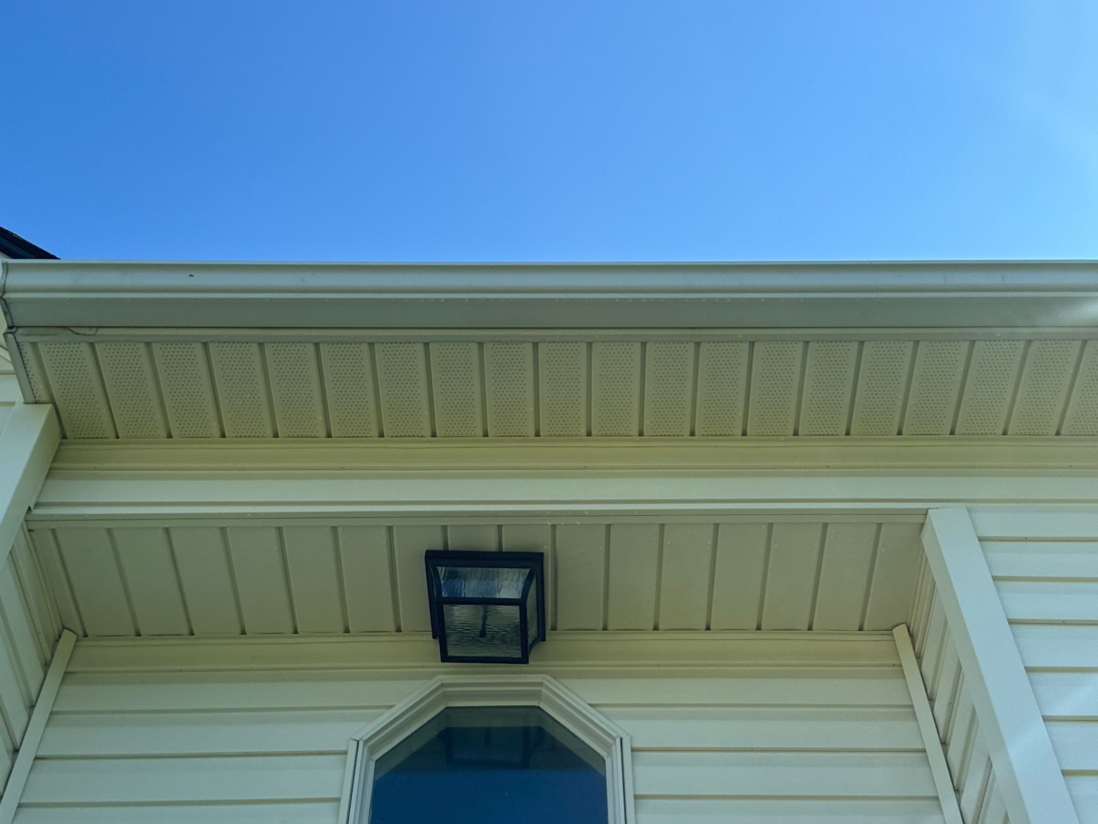 the service shown is cleaning the soffit and fascia of a house to remove dirt and grime buildup