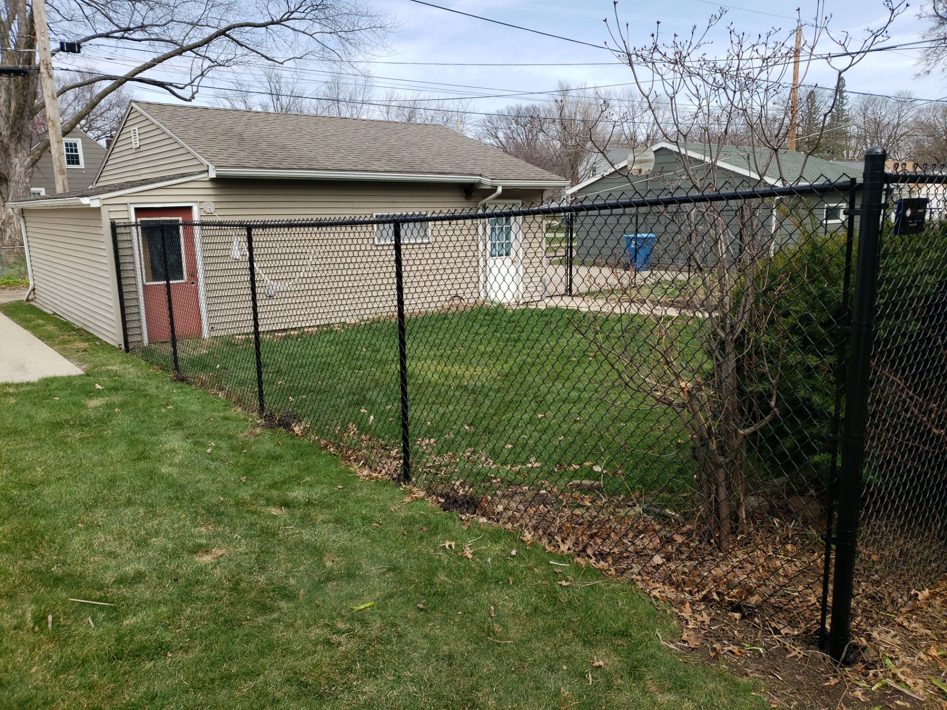 Black Vinyl Coated Chain Link Fence Installation in Waterloo by Perfect Picket Fence and Stain