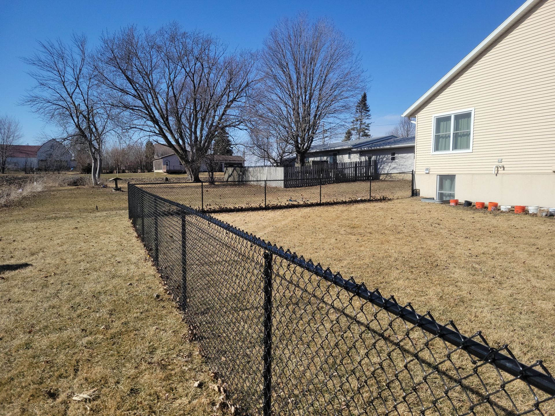 Residential Black Chain Link Fence and Gate Installation in Tripoli by Perfect Picket Fence and Stain