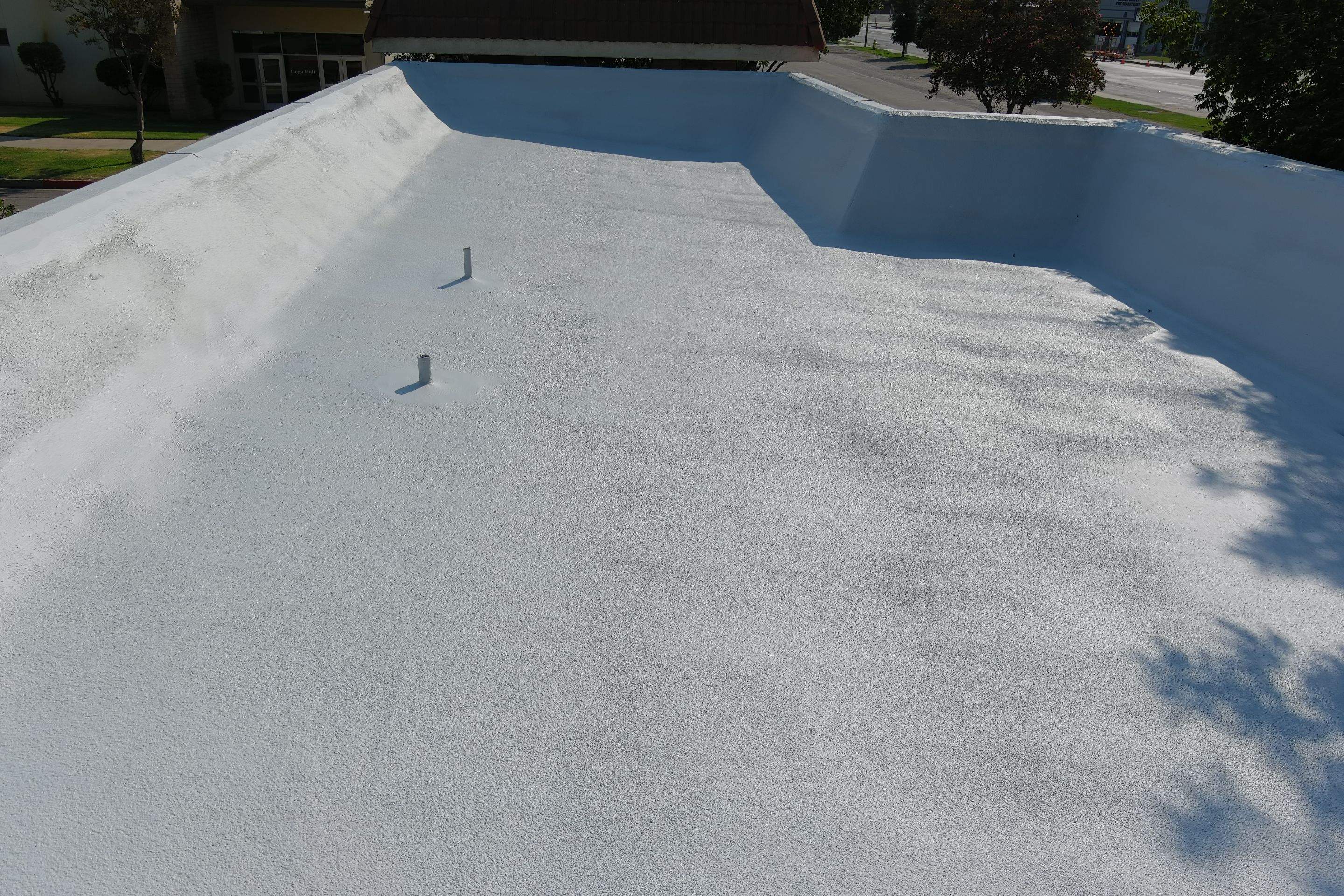 Commercial Roofing Installation using General Coatings acrylic coatings and spray foam by Straight Edge Roofing Inc