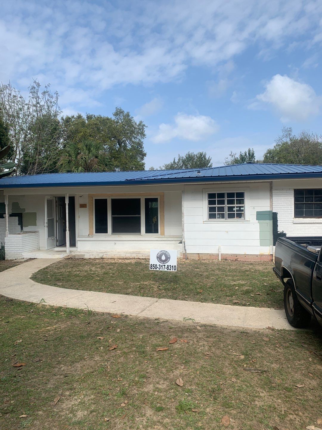 White Seamless Gutters and Black Downspouts by Gutter Professors