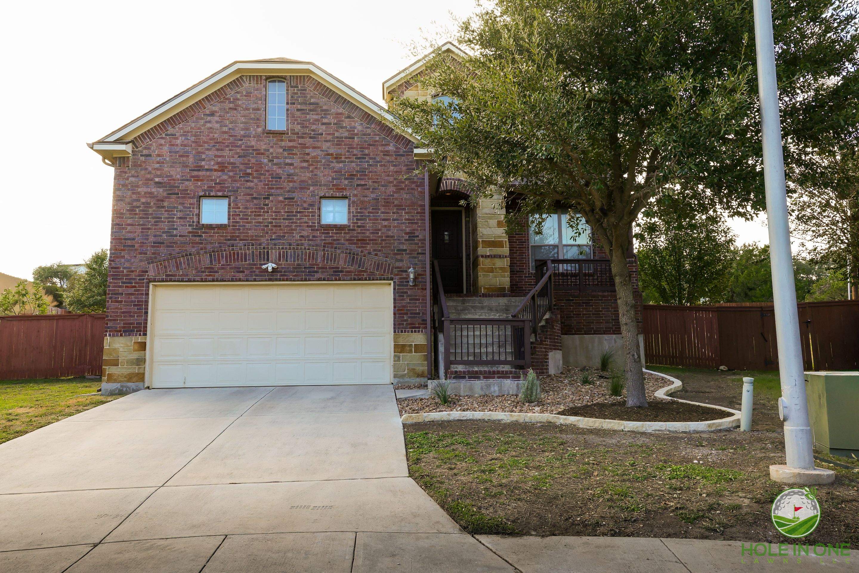 Low-Maintenance Front Yard Xeriscape with Chopstone Border, North San Antonio TX by Hole In One Lawns, LLC