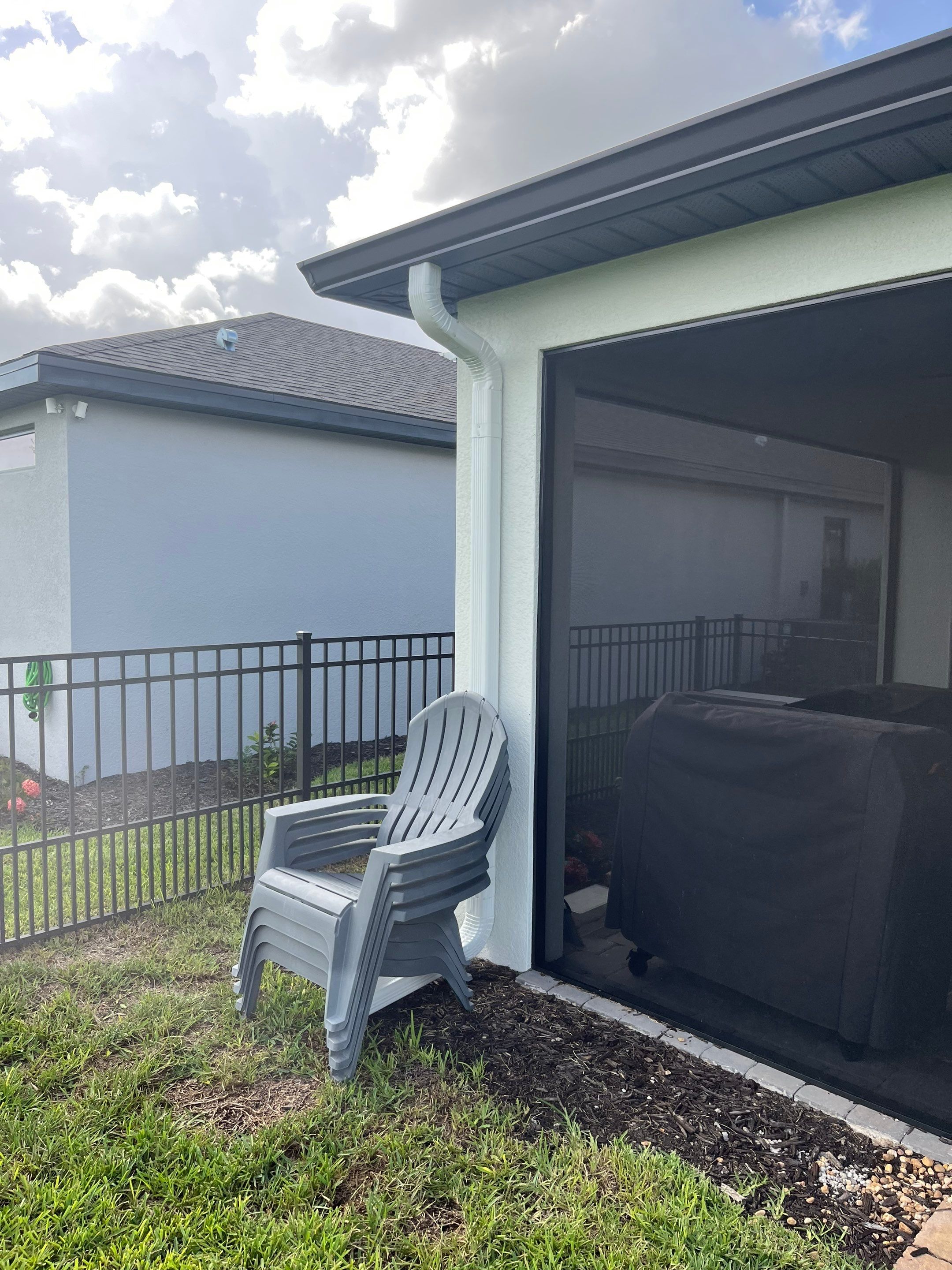 Dark Bronze Gutters and White Downspouts in Sarasota FL by Gutter Professors