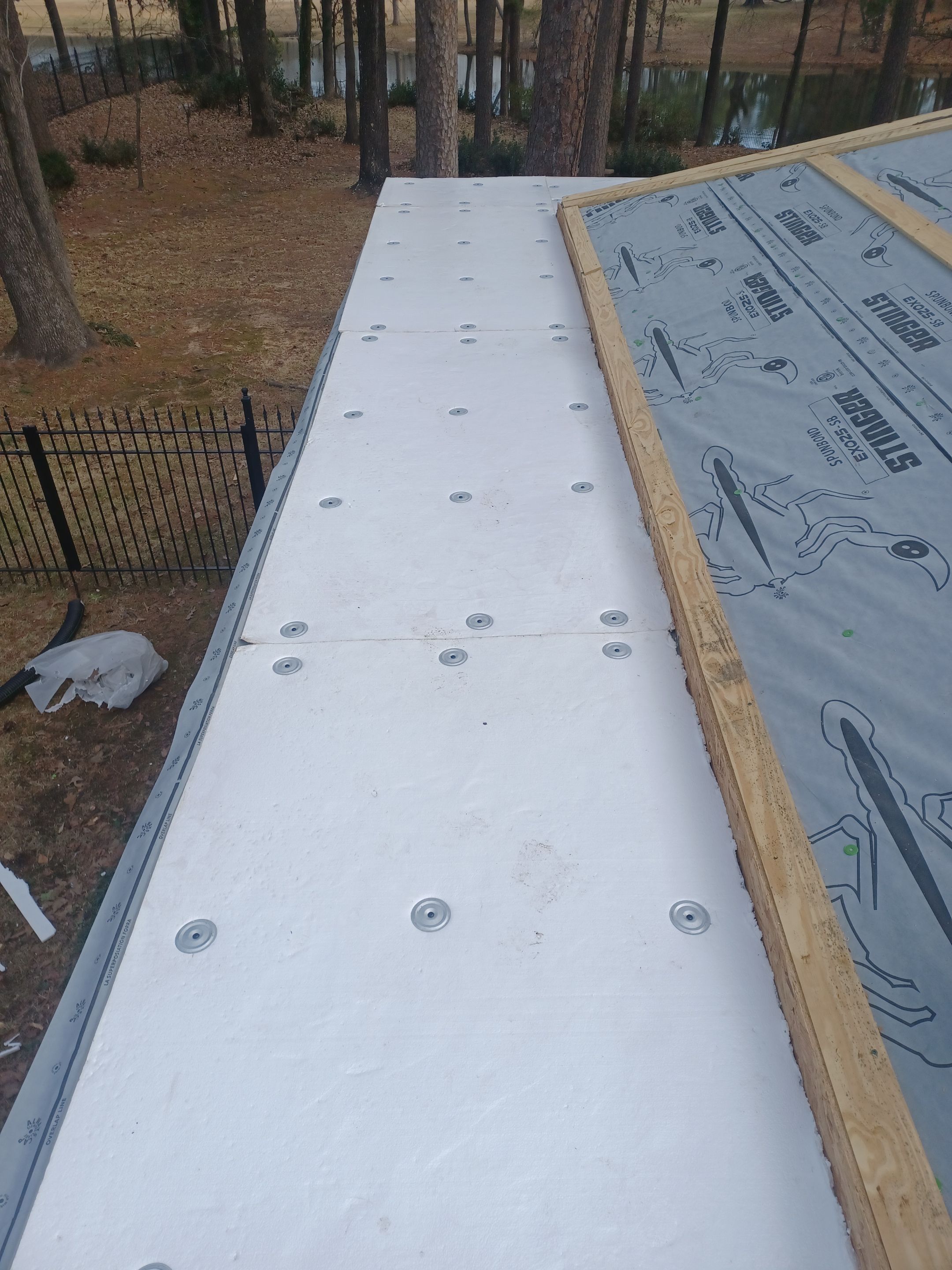 Residential Roofing Installation using PVC membrane and 24 gauge Standing Seam Metal by Hostetler Roofing