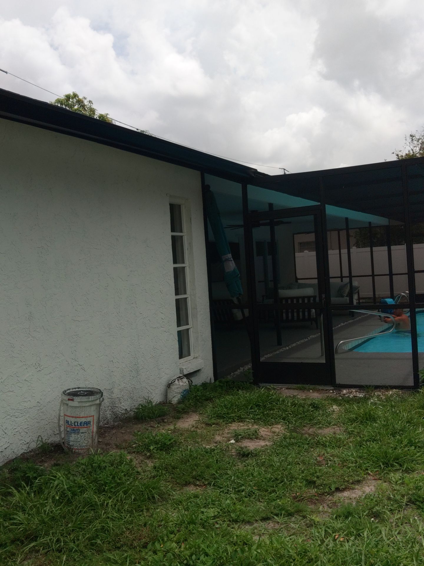Black seamless gutters and downspouts installation in Sarasota, FL by Gutter Professors