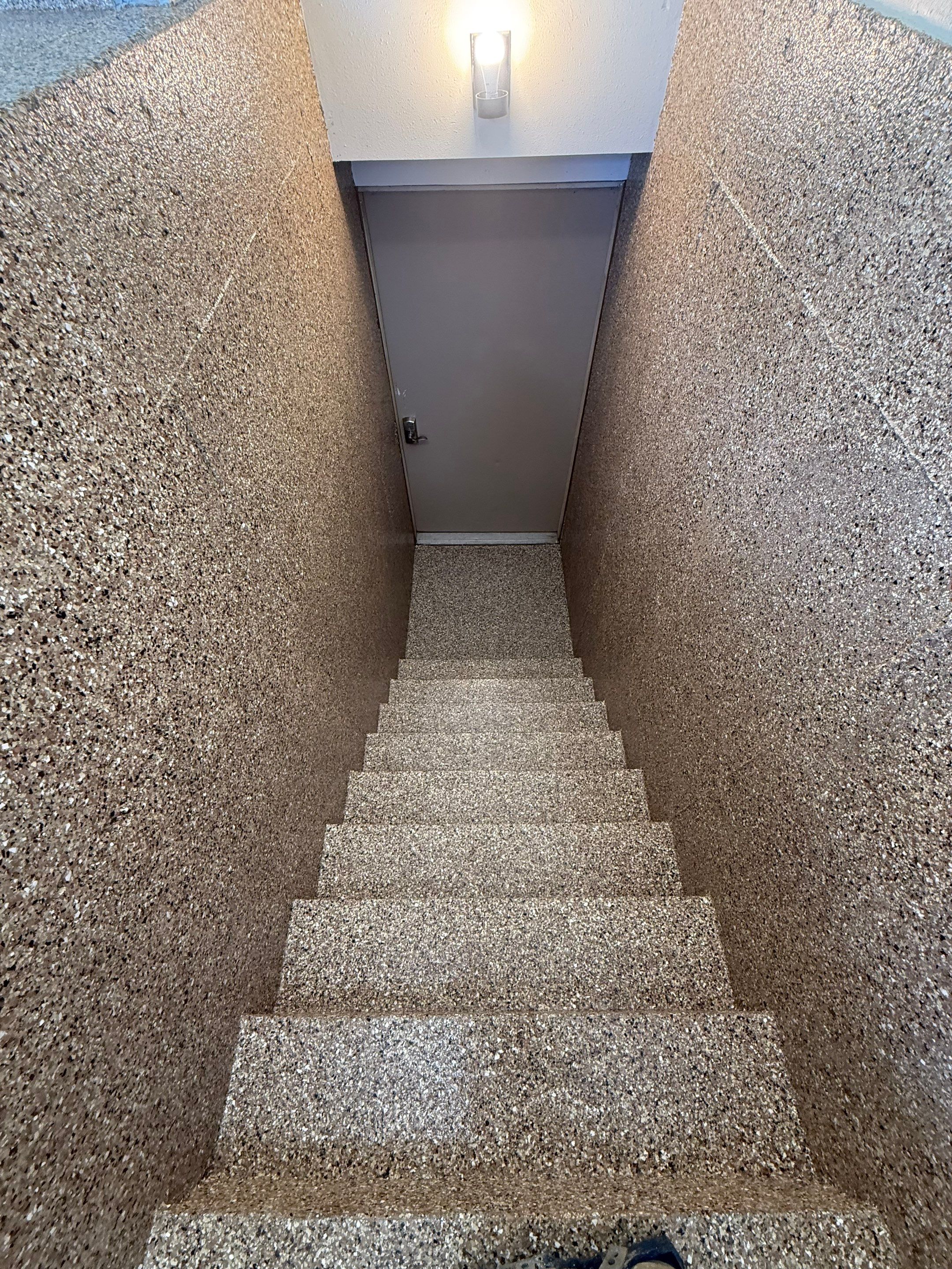 Custom Polyaspartic Garage Floor and Stairwell Coating in Pipestone by Select Painting, Coatings & Garage Cabinets