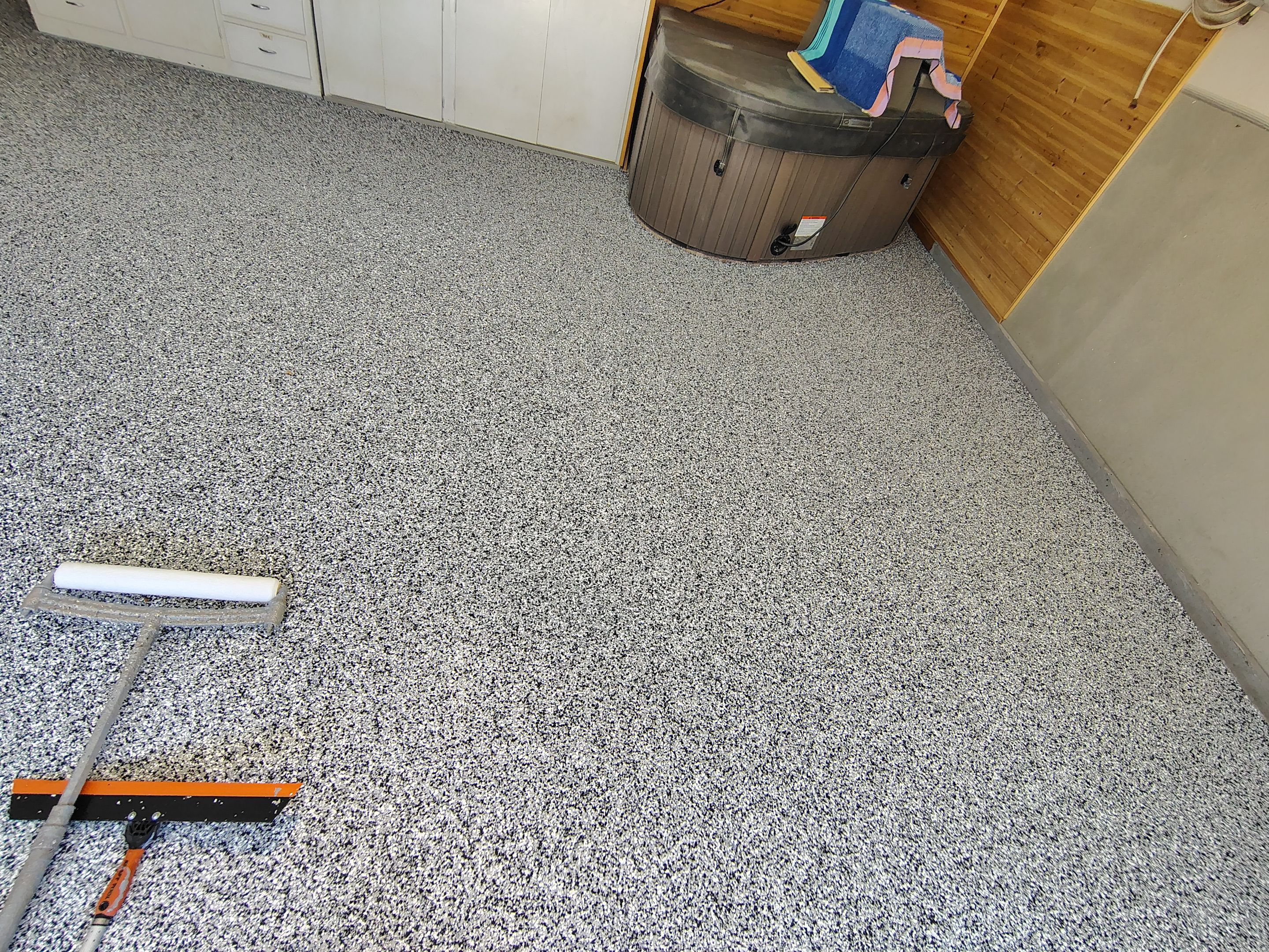 Domino Flake Garage Floor Coating Installation in Sioux Falls by Select Painting, Coatings & Garage Cabinets