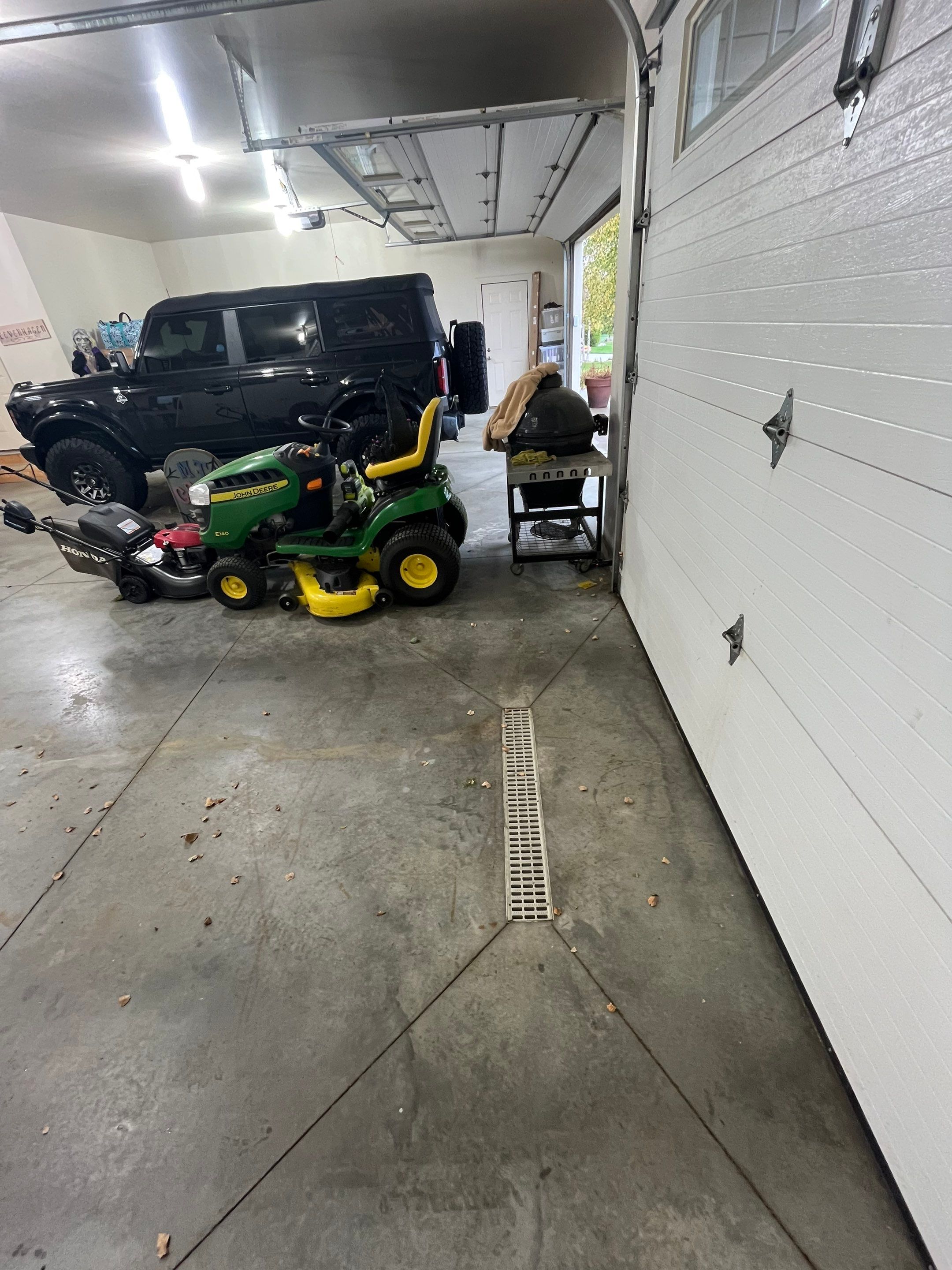 Coyote Flake Garage Floor Coating in Sioux Falls with Trench Drain by Select Painting, Coatings & Garage Cabinets