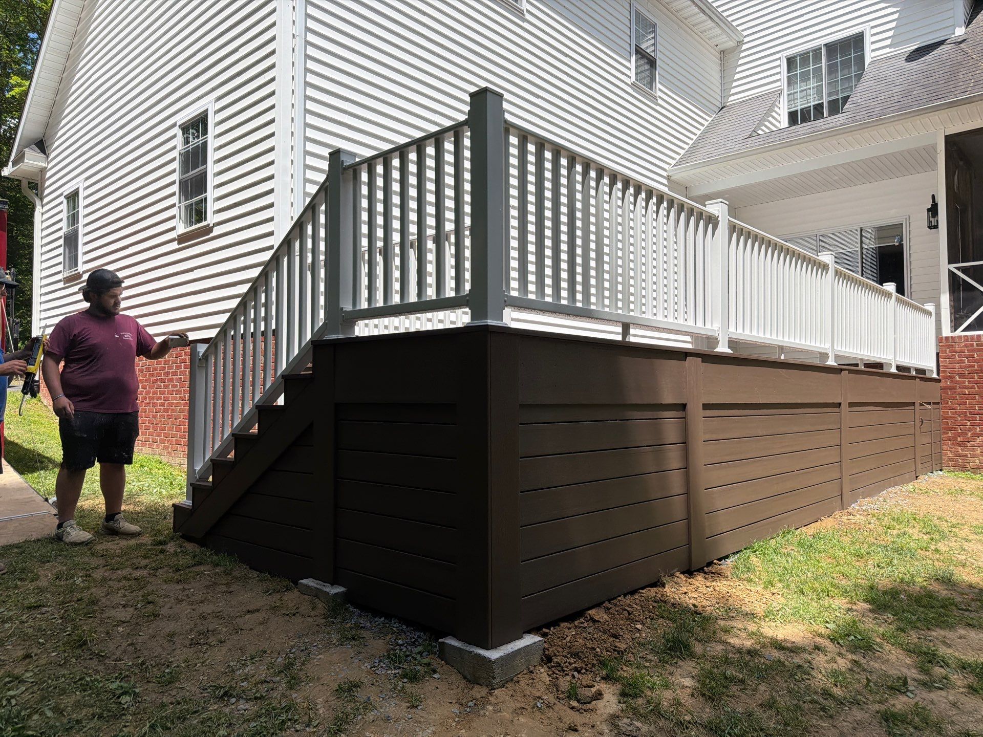 Custom Composite Deck and White Vinyl Railing Installation in Fayetteville by Walnut Hollow Decks & Outdoor Living