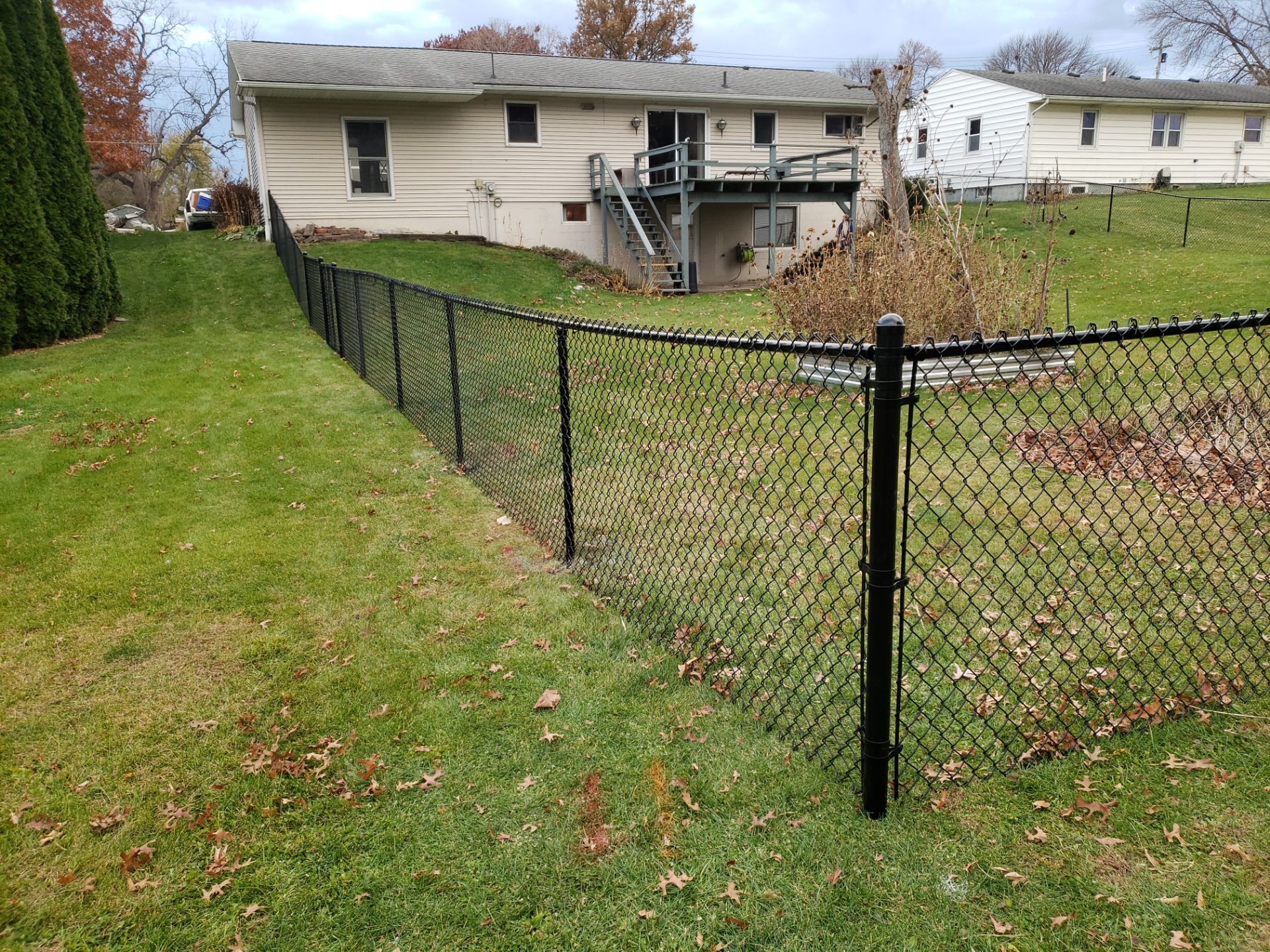 Residential Black Vinyl-Coated Chain Link Fence in Grundy Center by Perfect Picket Fence and Stain