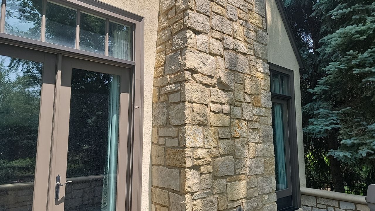 Northbrook, IL stucco home soft wash and stone cleaning by Northern Power Washing LLC.