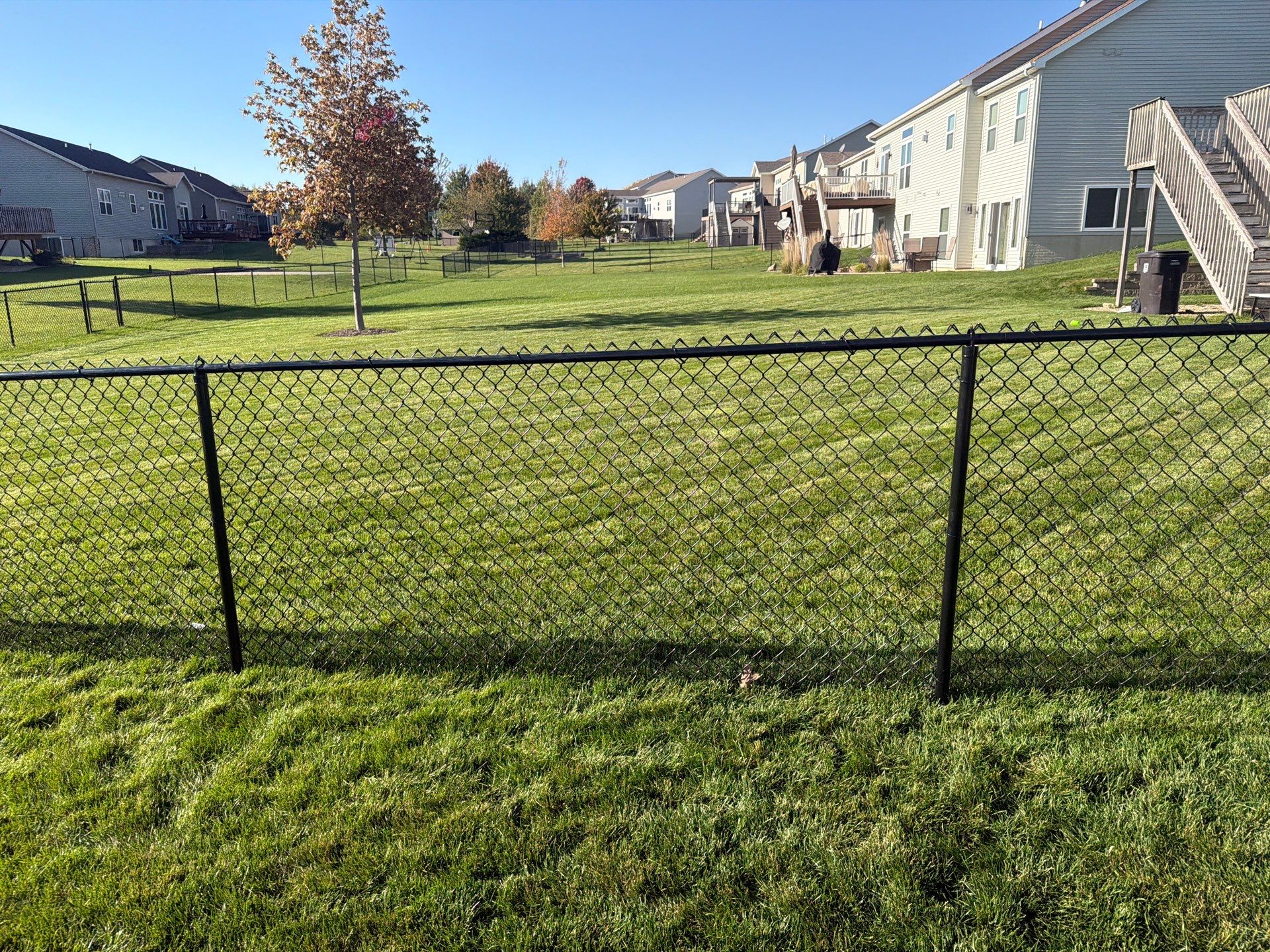Black Vinyl-Coated Chain Link Fence Installation in Cedar Falls by Perfect Picket Fence and Stain