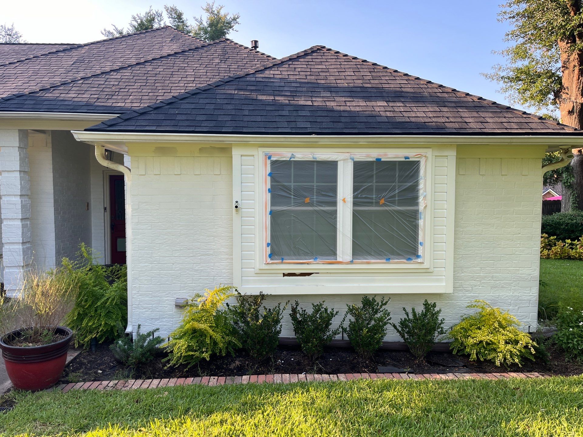 Exterior Painting in Tyler, TX | Brick House with White & Blue Finish by Quality Coats Painting