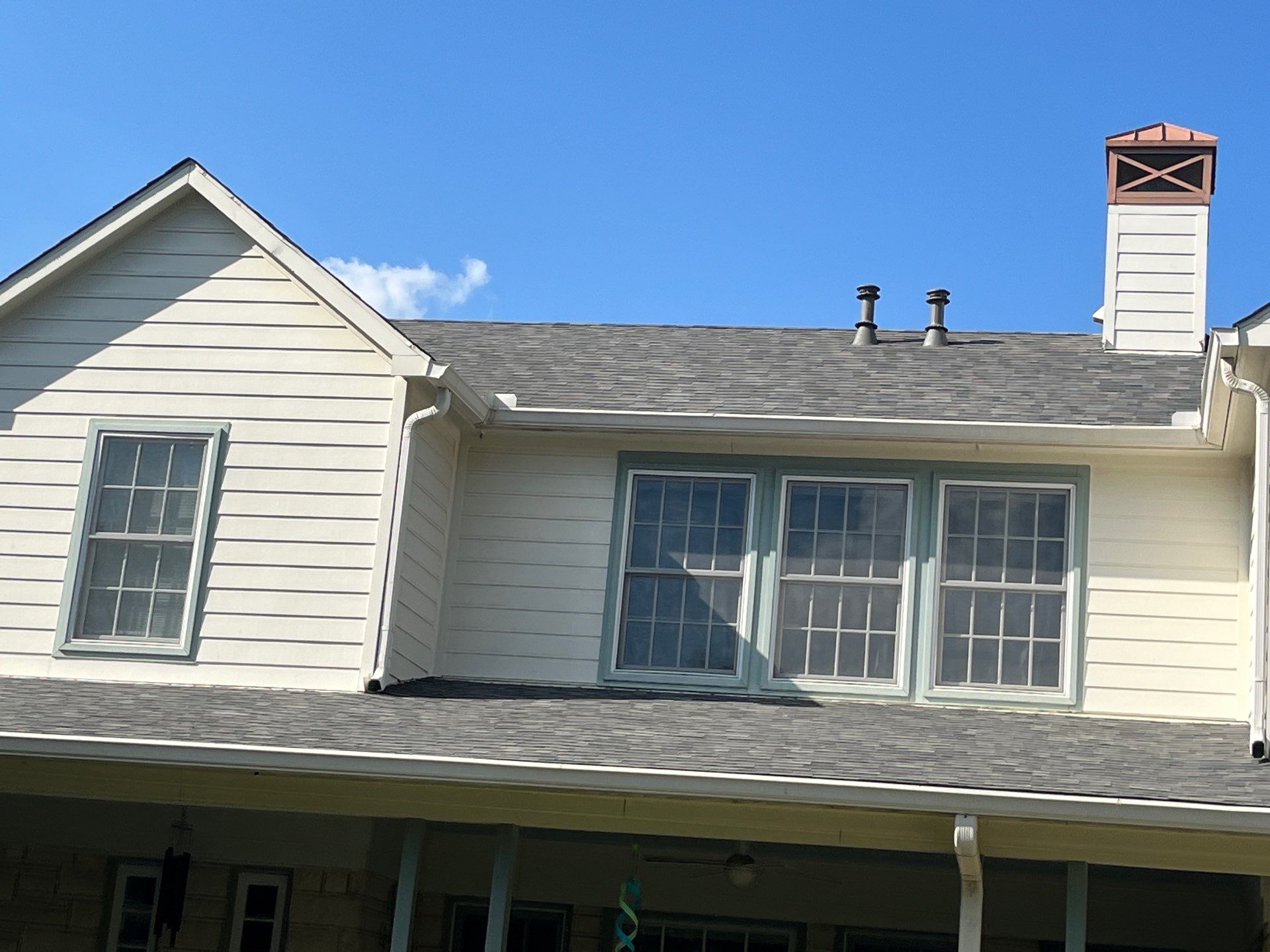 White brick with Malarkey Storm Grey by Tejas Roofworks + Restoration