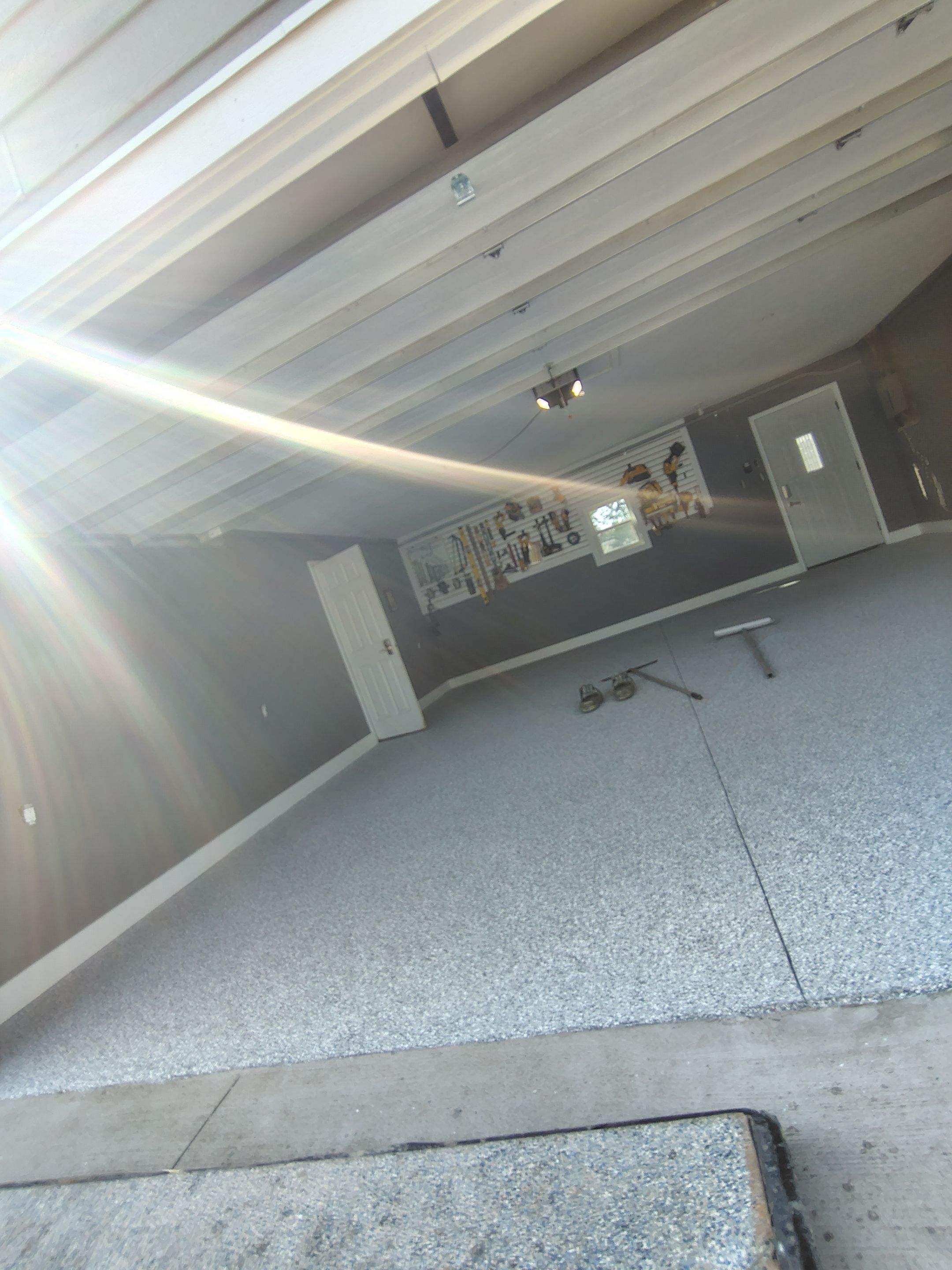 Custom Garage Floor Coating and Backyard Patio Refinishing in Tyndall by Select Painting, Coatings & Garage Cabinets