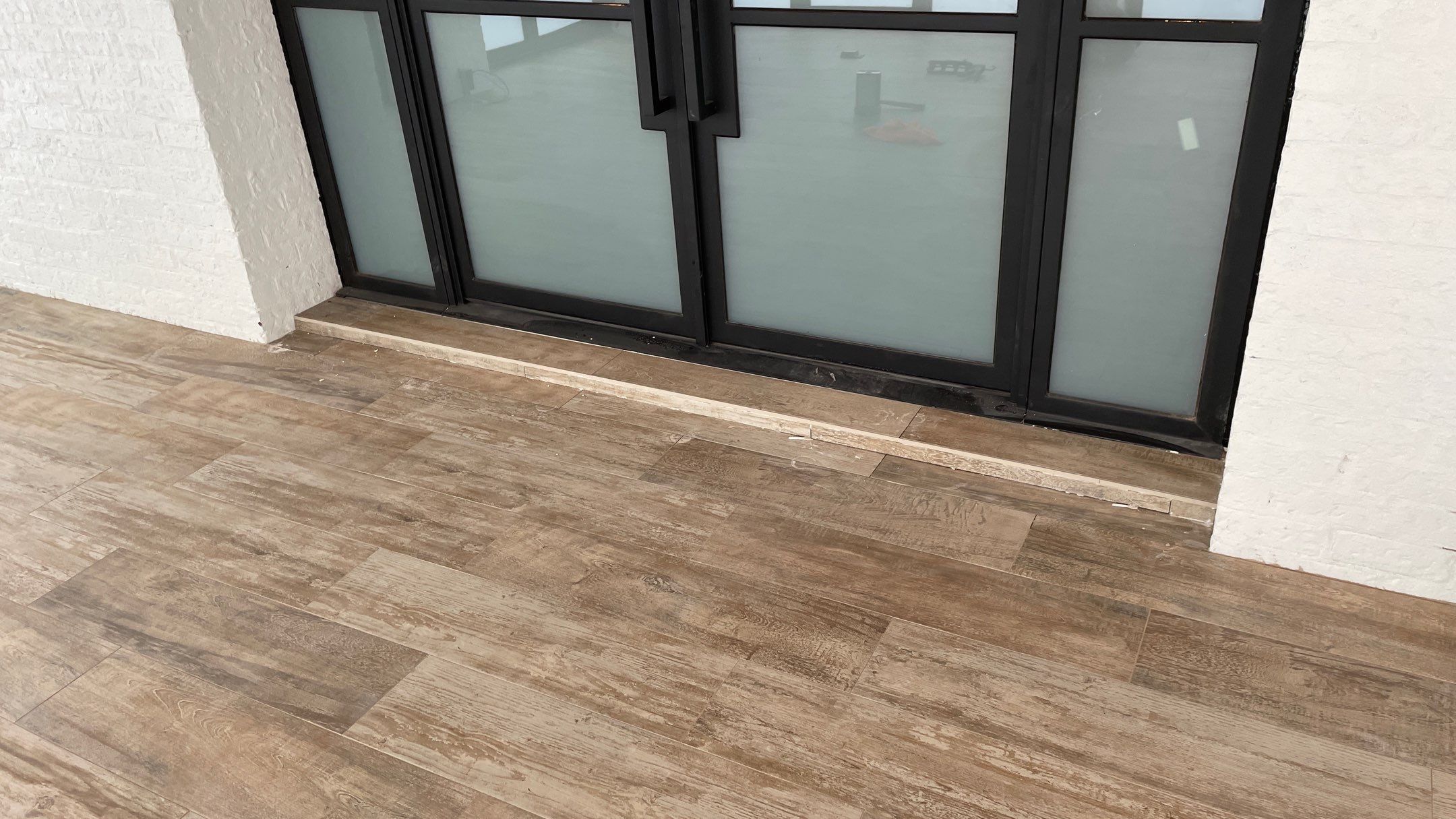 Instant Transformation of this Beautiful Sunroom by Footprints Floors of Coastal Carolina