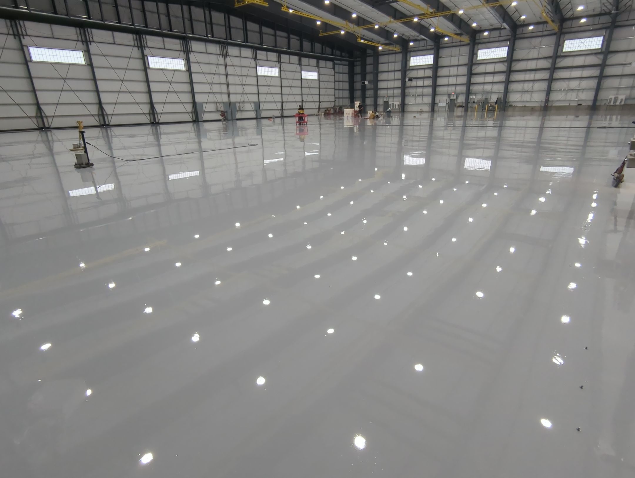 Airplane Hanger using Light Grey Commercial Penntek Epoxy by Croc Coatings, LLC