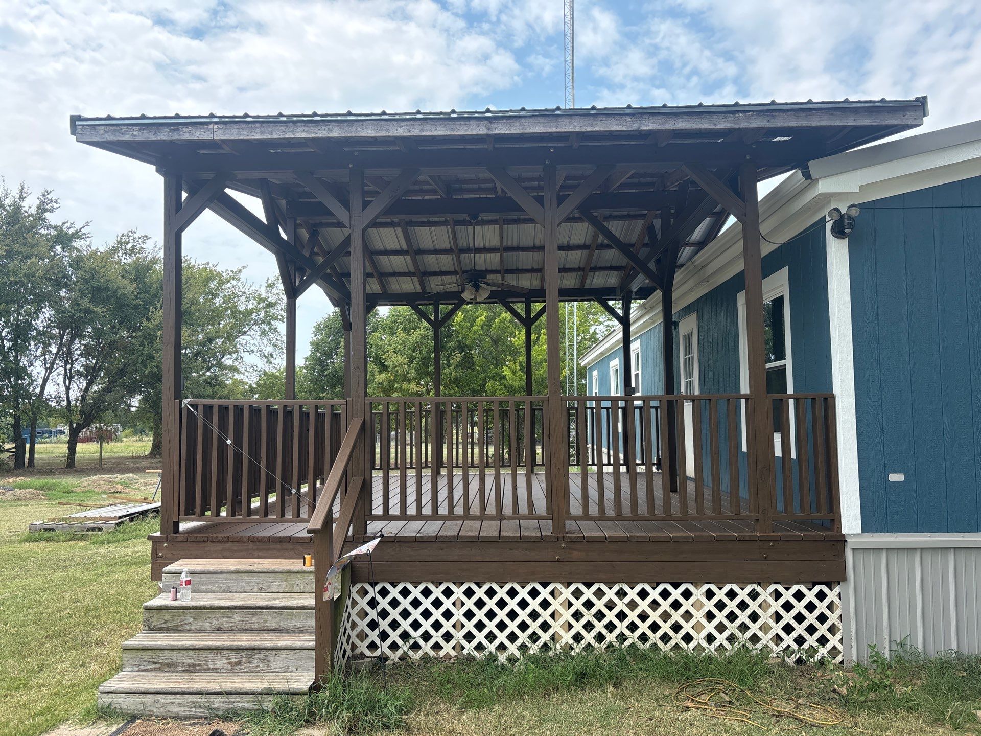 Exterior Painting in Fruitvale, TX | Wood Porch & Home in Deep Navy Blue by Quality Coats Painting