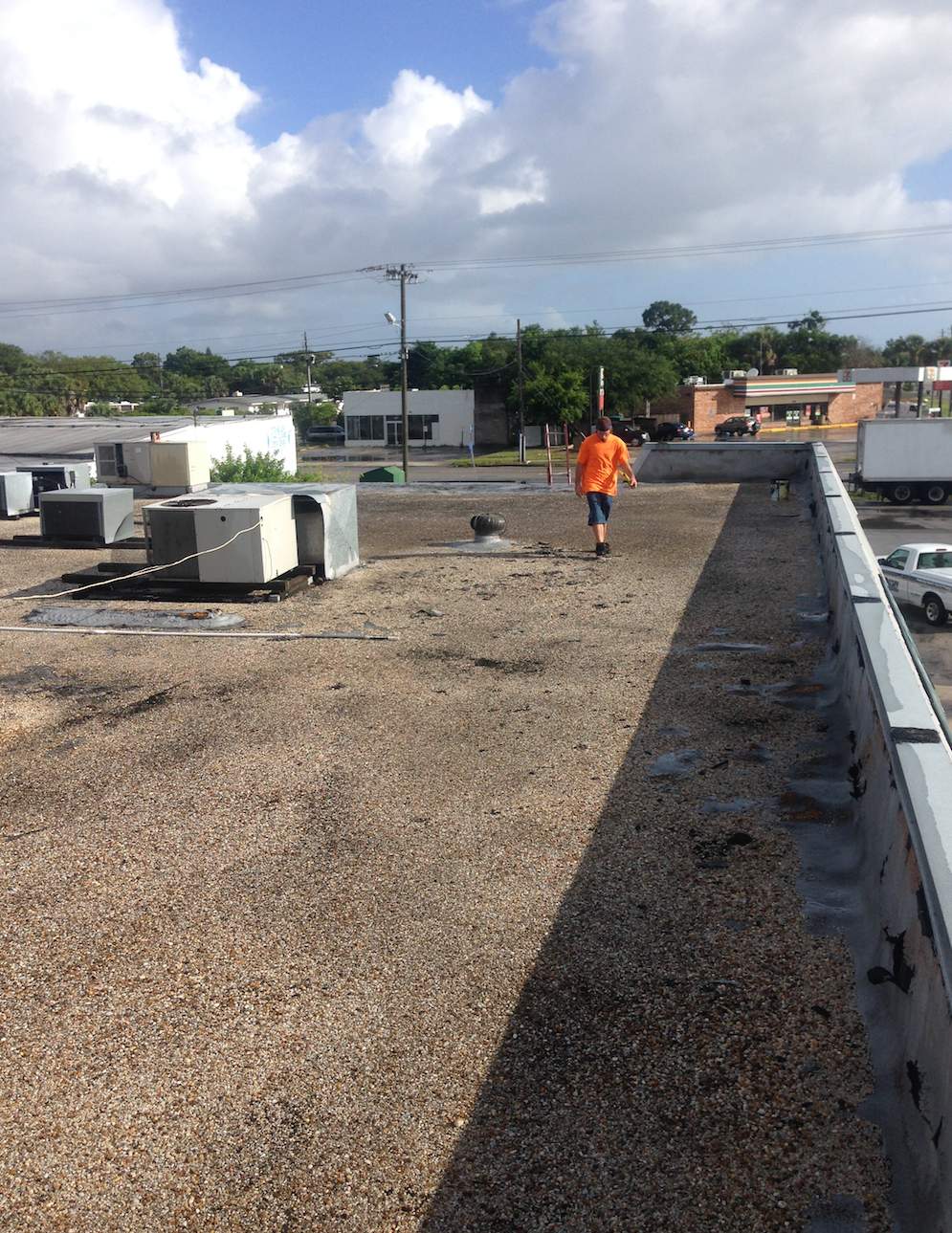White Reflective Commercial Roof Coating Installation in Melbourne FL by Florida Roofing and Renovations Inc.