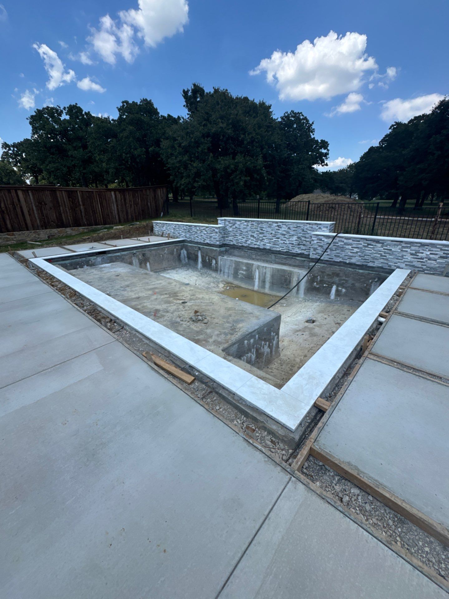 Geometric Pool with Stacked Stone Water Wall by Pinnacle Pools and Spas - DFW