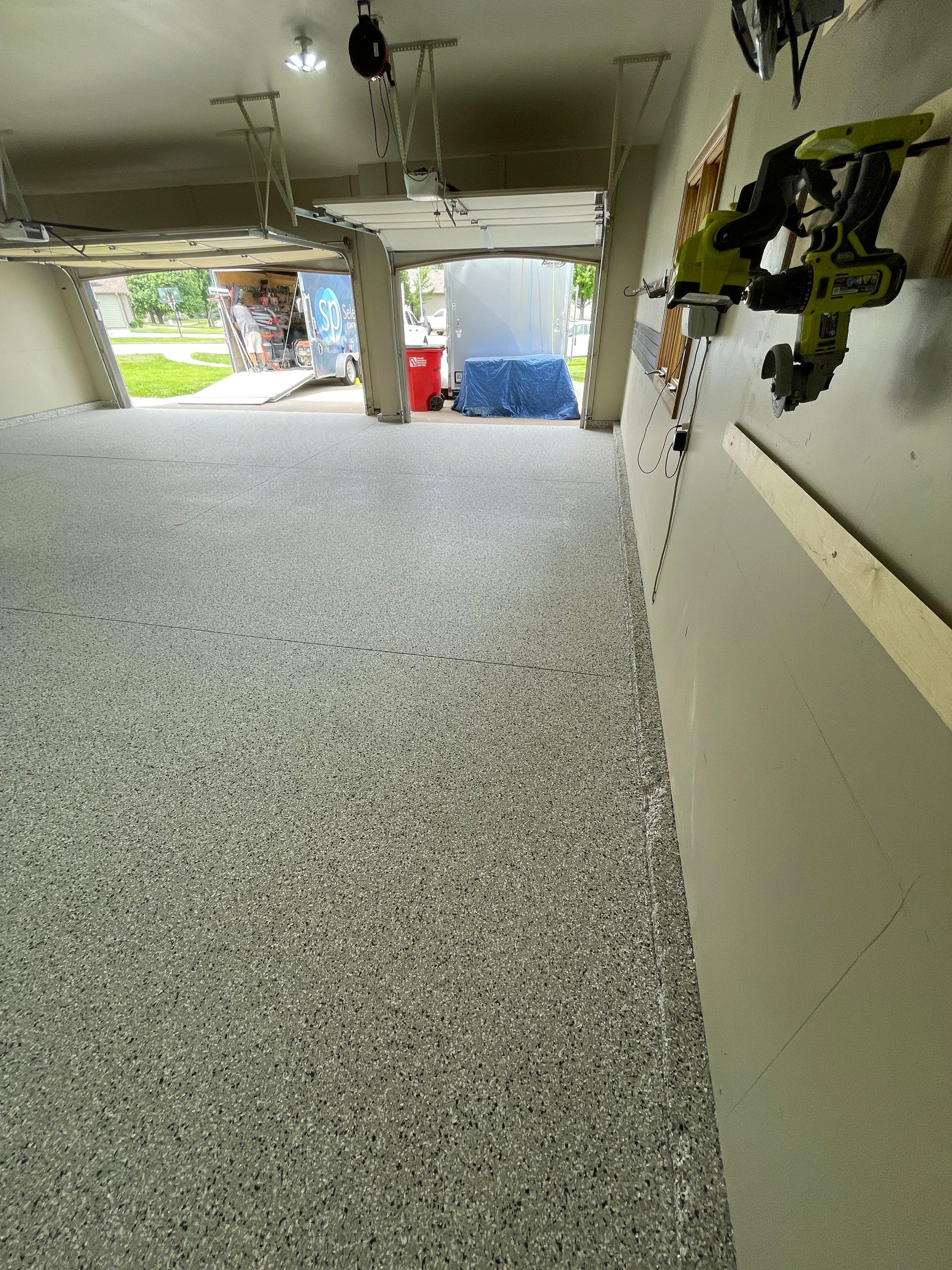 Cabin FEver Flake Garage Floor Coating Installation in Sioux Falls by Select Painting, Coatings & Garage Cabinets