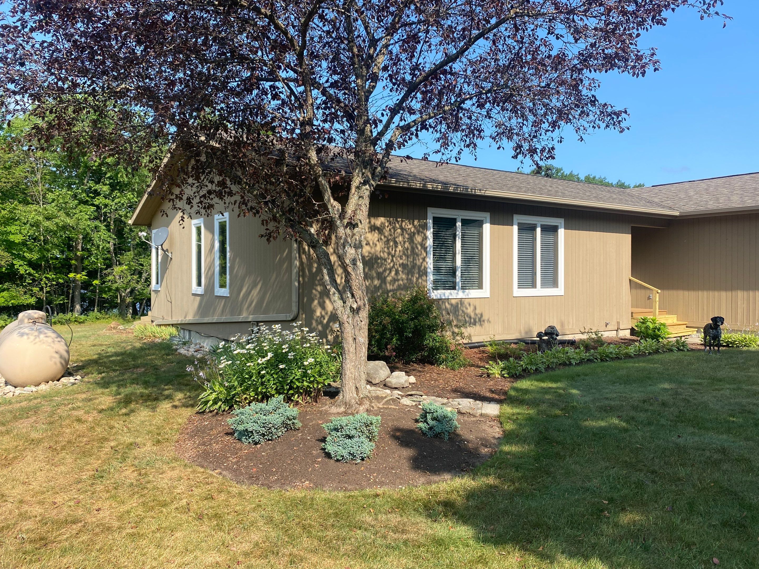 Off-White Aluminum Gutter and Downspout Replacement in Charlevoix by Rainbow Seamless Systems