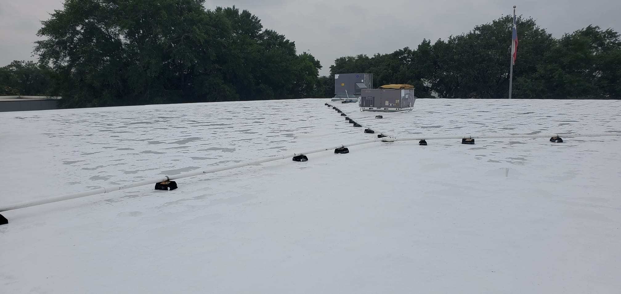 Flat Roof Coating Installation by Houston Roofing & Construction