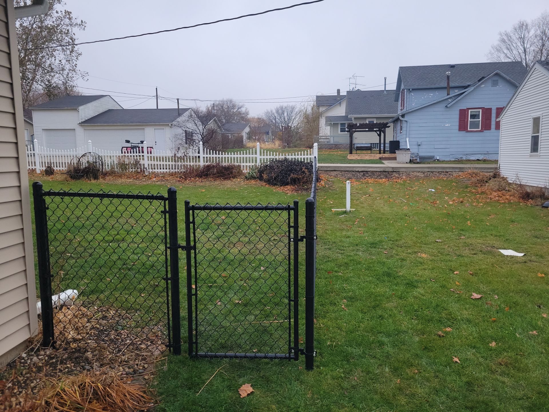 Black Vinyl-Coated Chain Link Fence Installation in Aplington by Perfect Picket Fence and Stain