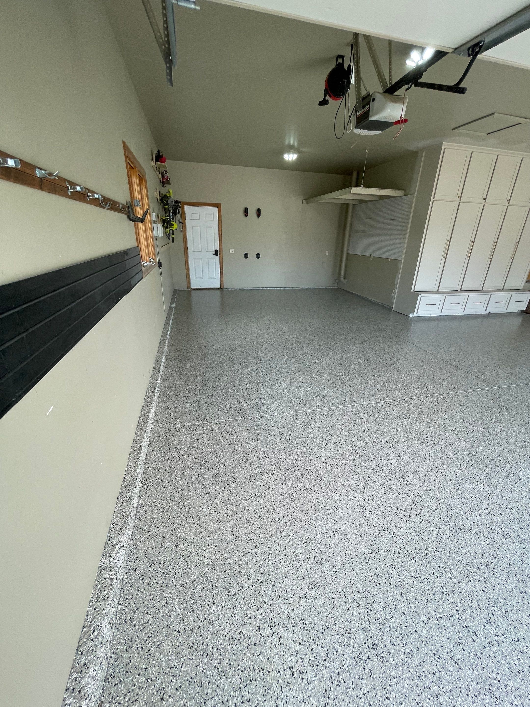 Cabin FEver Flake Garage Floor Coating Installation in Sioux Falls by Select Painting, Coatings & Garage Cabinets