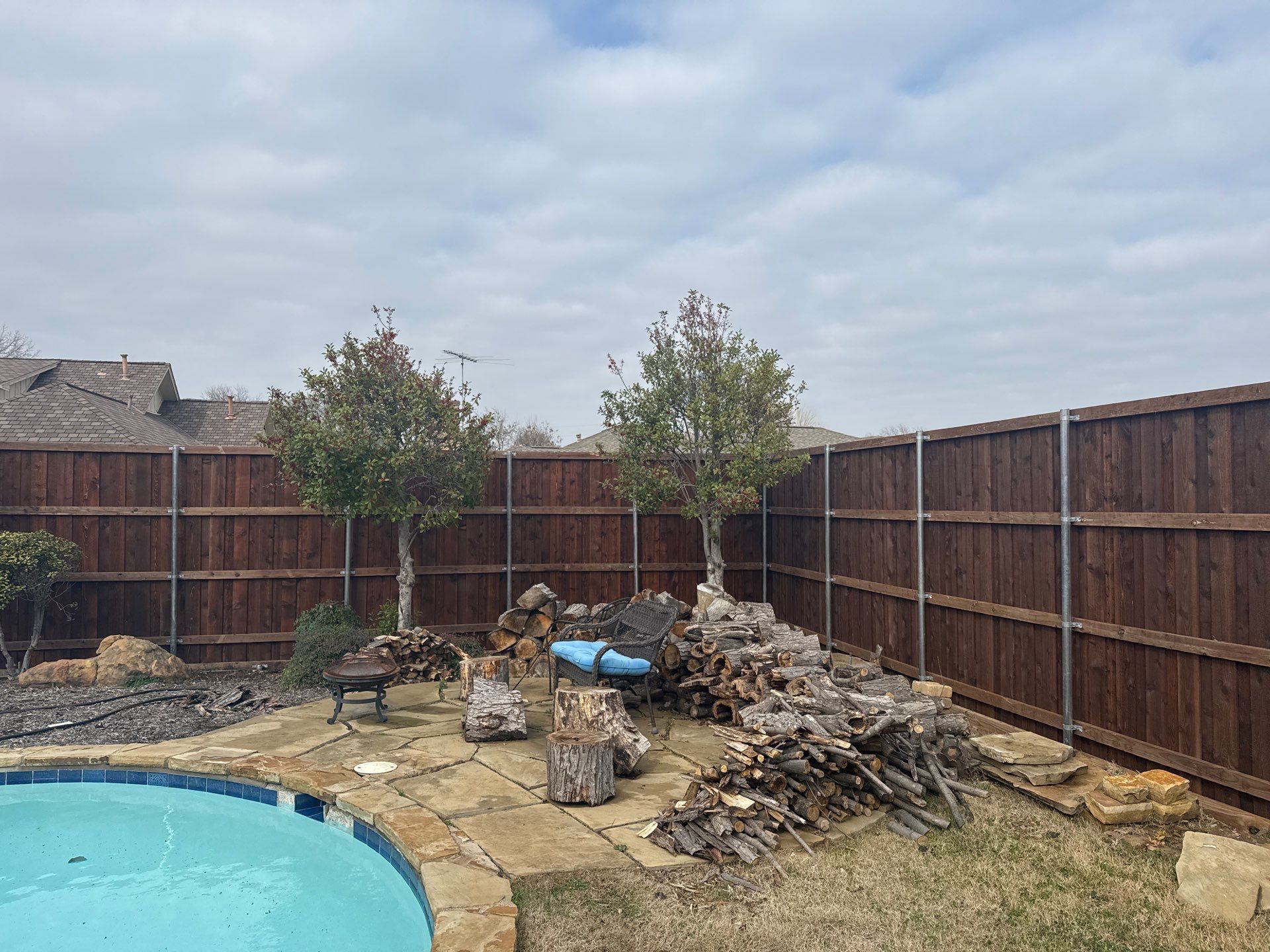 Pre-Stained board on board w/ trim and kickboard using 1x4 cedar trim by Grizzly Fence And Patio