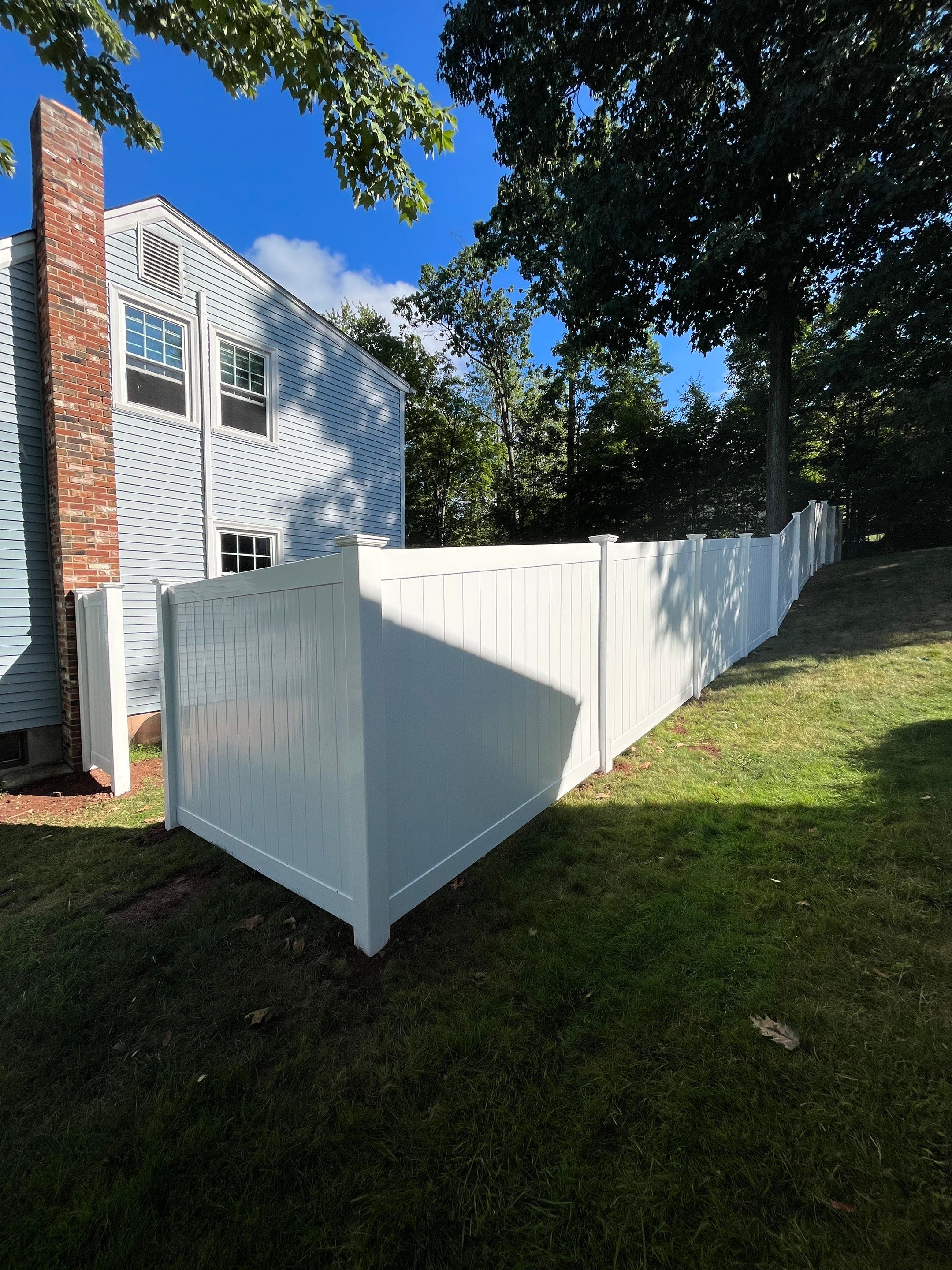 New Vinyl Privacy fence in White with matching gate by DiGiorgi Roofing and Siding Inc